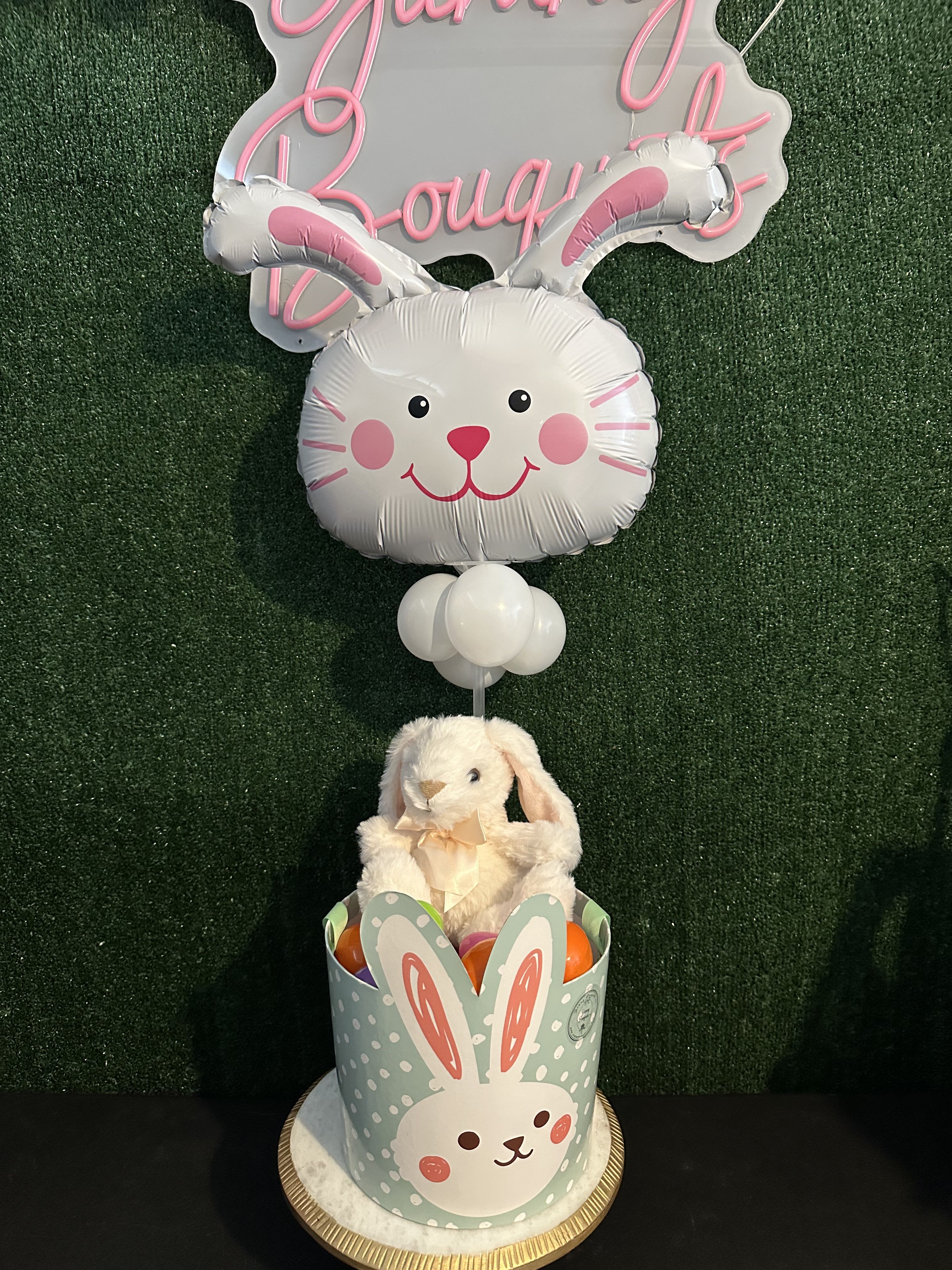 Bunny basket Bunny basket - Eggs, chocolates, basket, bunny, and balloons Flowers and color substitution may apply"