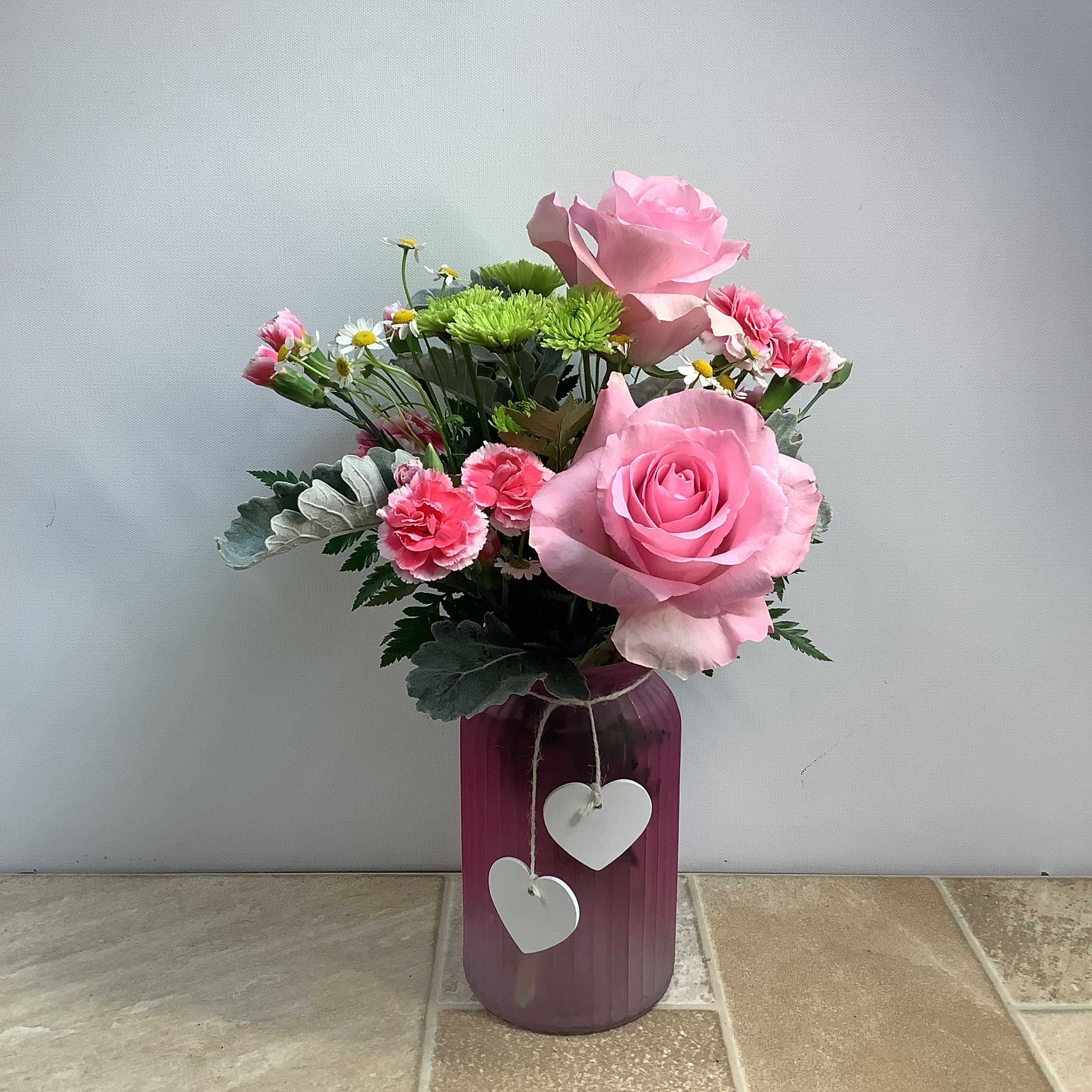 Perfectly Pink Perfectly Pink - Send someone special a “Perfectly Pink” arrangement of fresh roses, mini carnations, green athos and feverfew. It measures 10” wide x 16” tall.