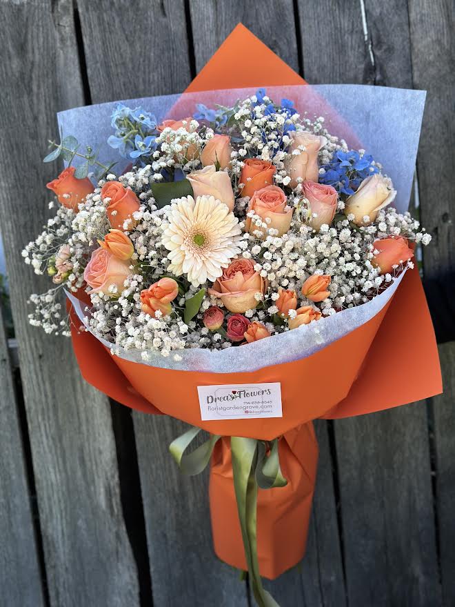 The OC The OC - Perfect for the orange oc person! Handheld bouquet , you may request certain color wrap, no vase included. Call to request vase if needed.