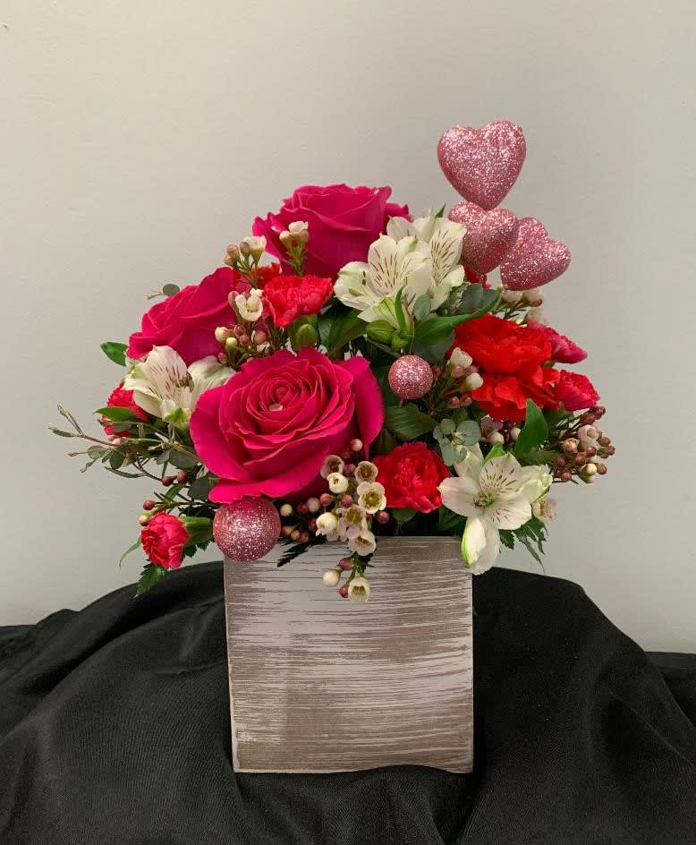 Country Cute Country Cute - This white washed wooden container is filled with roses, alstromeria, carnations, mini carnations and wax flower