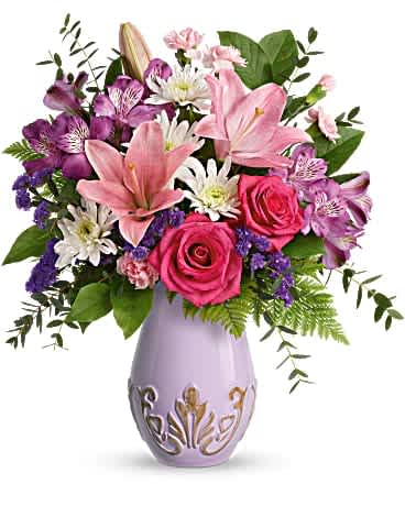 Teleflora's Lavishly Lavender Bouquet Teleflora's Lavishly Lavender Bouquet - Can't whisk mom off to Paris this Mother's Day? Do the next best thing: surprise her with this cheerful rose bouquet presented in this charming, elegantly-embossed vase! This feminine bouquet includes hot pink roses, pink asiatic lilies, purple alstroemeria, miniature pink carnations, white cushion spray chrysanthemums, purple sinuata statice, leatherleaf fern, parvifolia eucalyptus, and lemon leaf. Delivered in a Lavishly Lavender Vase.