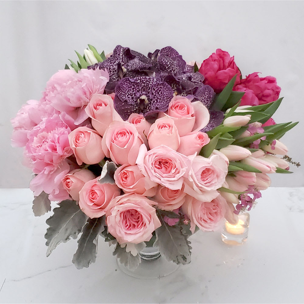 Leading Lady - Sophisticated and Superb! Leave a lasting impression with this abundant and lovely mix of pale pink Roses, pink Peonies, gorgeous purple Vanda orchids, and pink Tulips ~ all in a contemporary glass vase. 16&quot; Tall. 