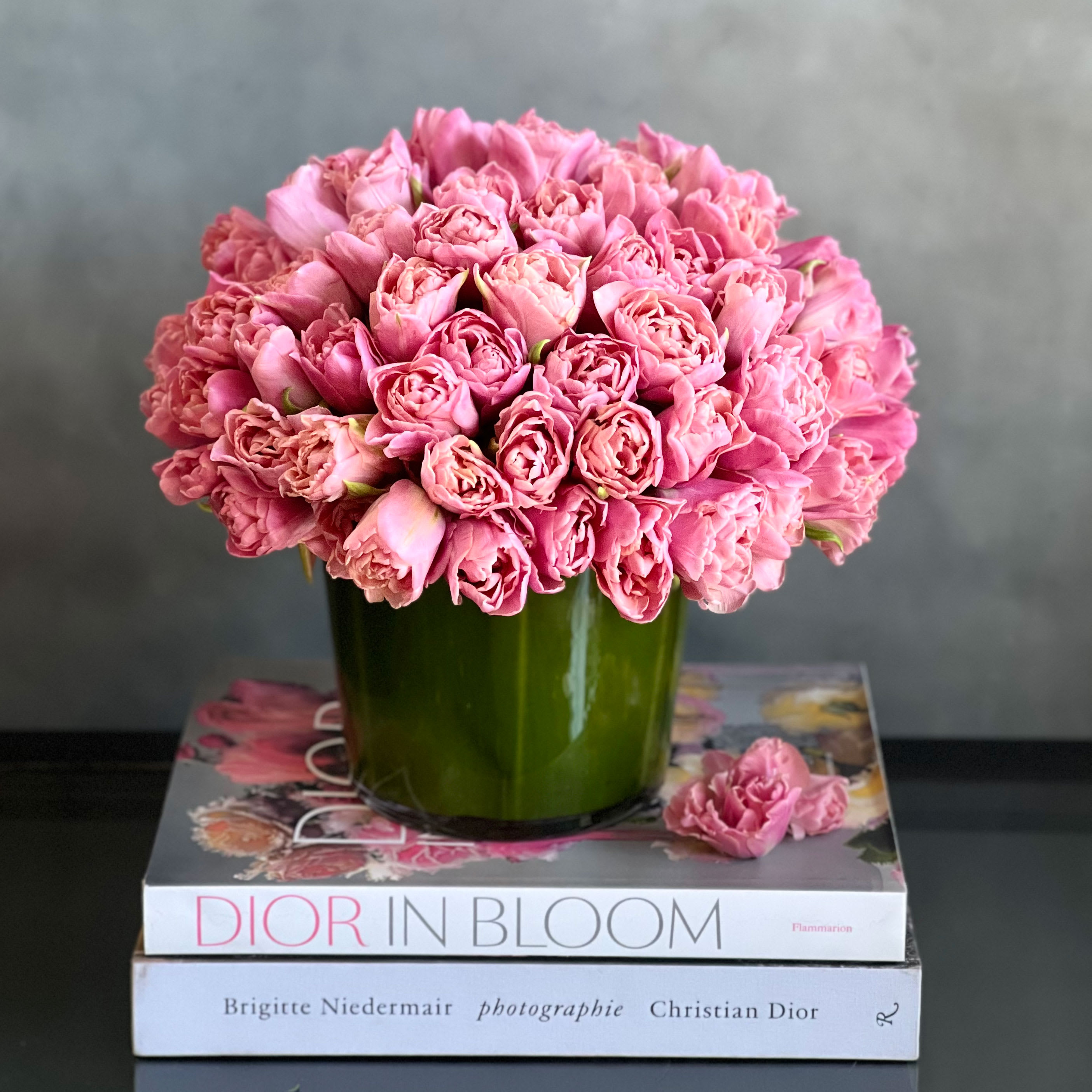 M's Tulips  - A beautiful and simplistic accent of Tulips arranged within a cylinder glass vase. A vast array of pink tulips to brighten up any day ! Perfect for a birthday, just because and simply thinking of you ! 