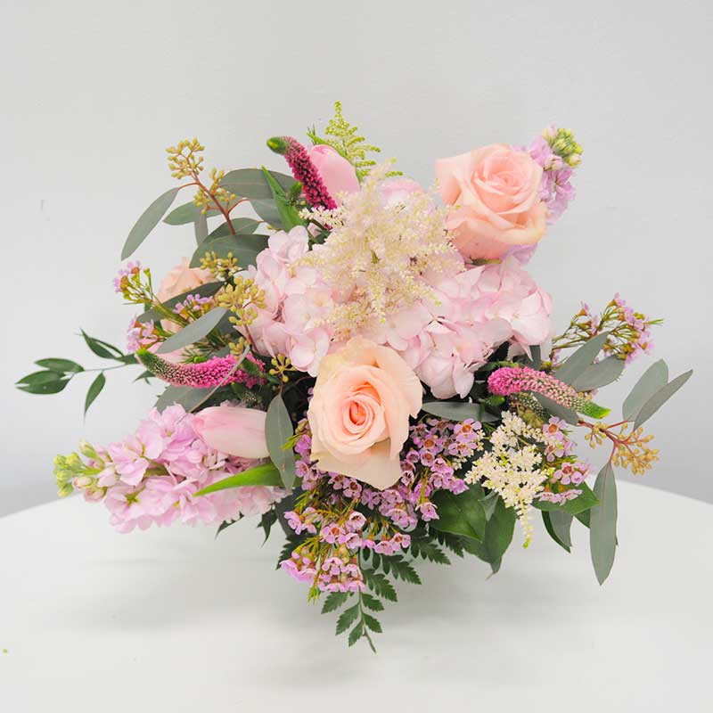 K2405 Pretty in Pink  - KMD2405 Pretty in Pink  For any pink-loving person, this arrangement is a dream come true, featuring a myriad of shades and shapes of the beloved color pink. From delicate Hydrangeas to classic Roses, fragrant Stock, , and the whimsical charm of Wax Flower. It's a pink paradise that's impossible not to love! This original local design is available for delivery anywhere we serve. Surprise that special person in your life with this enchanting bouquet.                                                                                                                     