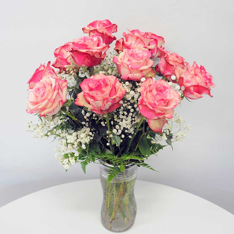 RV12M One Dozen Magic Times Roses  - RV2402MT Magic Times Roses – A bold departure from the traditional, these stunning Magic Times Roses bring a fresh and modern touch to any tribute. One of the newest and most captivating rose varieties, they bloom beautifully and last exceptionally well. Available in 12, 18, or 24 stems, each arrangement only becomes more breathtaking, making this a truly special and unforgettable choice.        
