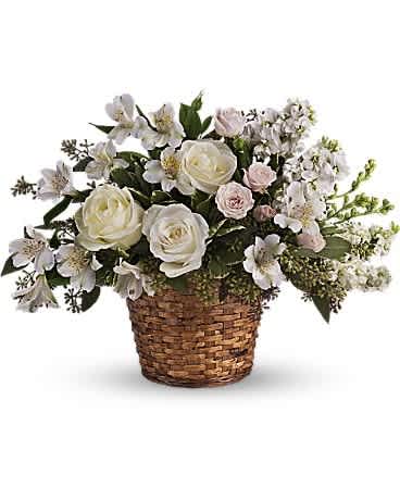 Love's Journey - Send comfort and thoughts of hope for a brighter day with this peaceful basket of white sympathy blooms, and a sweet hint of pink. Gently uplifting, it is perfect for the service. White roses, alstroemeria and larkspur along with pink spray roses are beautifully arranged in a natural-tone wicker basket.