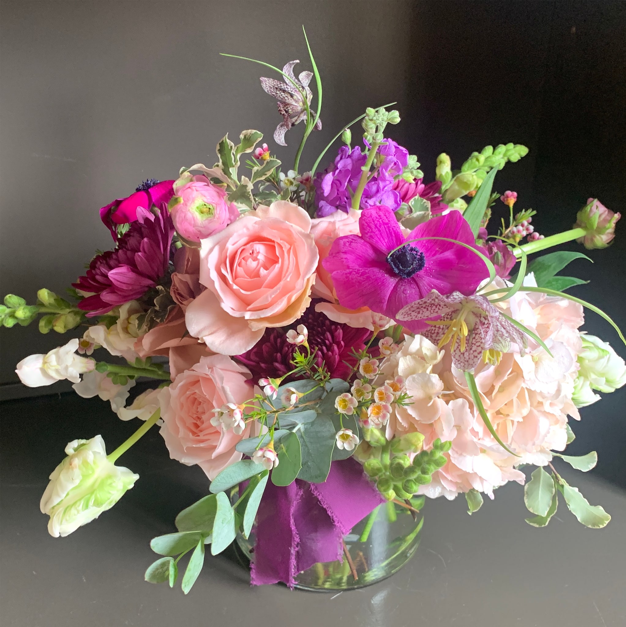 Raspberry Muse - Standard    |    A lush mix of seasonal blooms. Measures approximately 10&quot; tall x 10&quot; wide.  Deluxe    |    A lush mix of seasonal blooms. Measures approximately 12&quot; tall x 12&quot; wide.  Premium    |    Lush mix of seasonal blooms. Measures approximately 15&quot;+ tall and wide.   *Vessels are designer choice to complement flower selection unless specified.