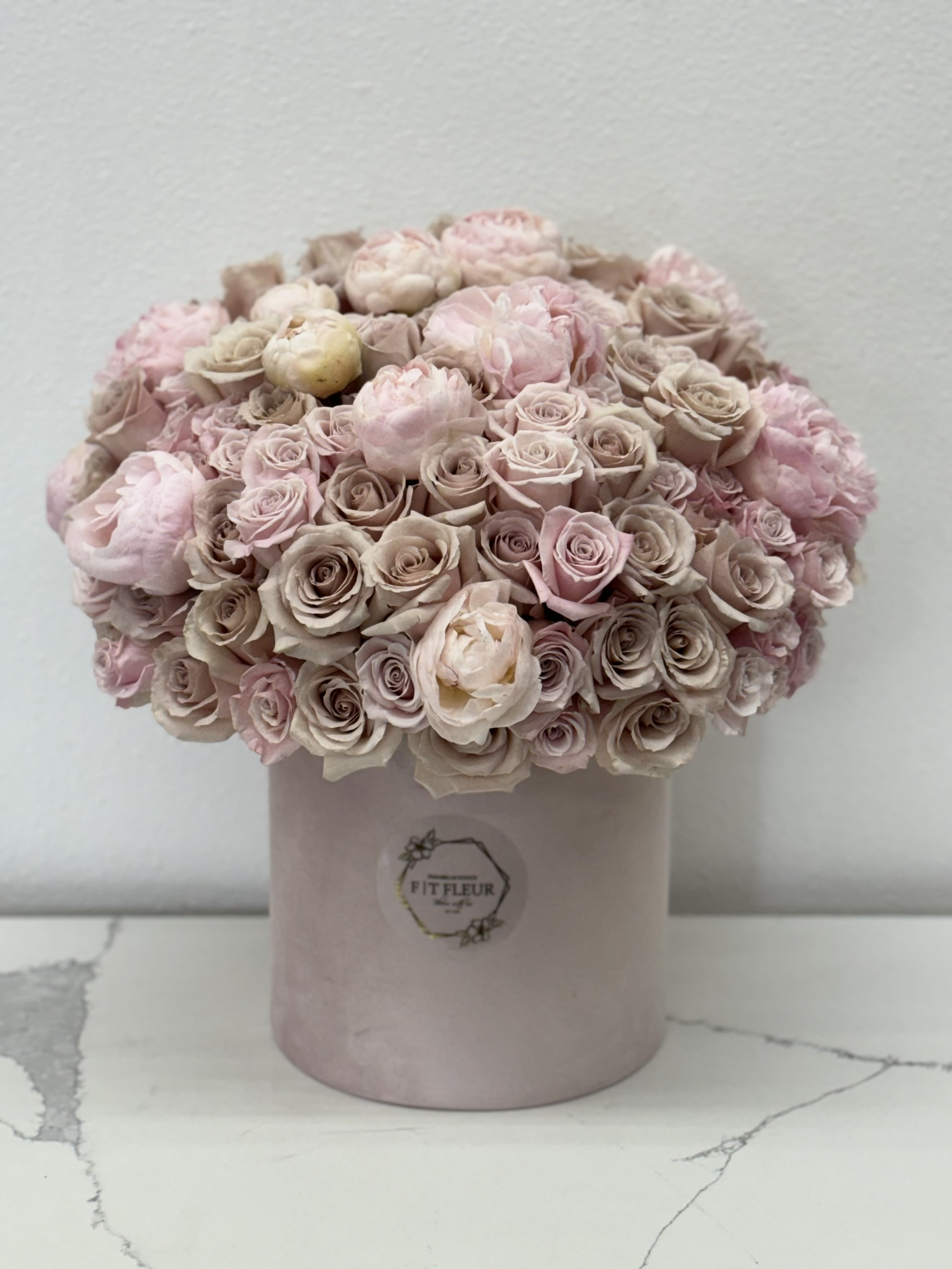 Nude blush Nude blush - **Beautiful Rounded Arrangement of Nude Roses and Hints of Peonies** Discover the perfect blend of elegance and charm with our beautiful rounded arrangement, featuring exquisite nude roses and delicate hints of peonies. Thoughtfully crafted by our talented design team, this stunning floral masterpiece is designed to bring a touch of sophistication to any setting. The soft, muted tones of the nude roses create a serene and inviting ambiance, while the playful peonies add a subtle pop of texture and dimension. This harmonious combination is expertly arranged in a rounded shape, making it an ideal centerpiece for intimate gatherings, weddings, or as a heartfelt gift for someone special. Each bloom is handpicked for its quality and beauty, ensuring that this arrangement not only looks breathtaking but also carries a personal touch. Perfect for adding a touch of romance to your home or celebrating life’s special moments, this rounded arrangement is a timeless expression of love and appreciation. Let our handpicked design designers create a stunning floral experience that will leave a lasting impression!