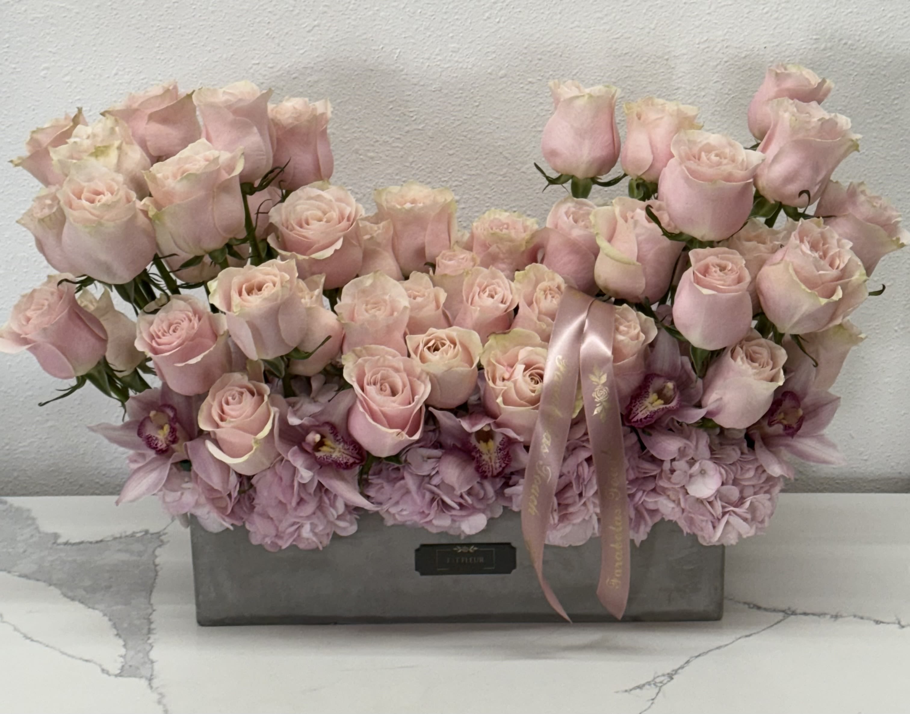 Mandy bloom  - **Elegant Pink Roses Arrangement: Elevate Your Special Occasion**  Celebrate your special occasion with our beautiful and elegant pink roses arrangement, designed to add a touch of grace and charm to any event. Each bloom is carefully selected for its vibrant color and exquisite quality, resulting in a stunning display that radiates beauty and sophistication.  This arrangement features a lush gathering of soft pink roses, symbolizing love and admiration. The rich, velvety petals are arranged to create a harmonious flow, making it a captivating centerpiece that draws the eye and warms the heart. Perfect for weddings, anniversaries, or any cherished celebration, this elegant design is sure to elevate your event to new heights.  Whether placed on a dining table, at a ceremony, or as a thoughtful gift, this arrangement embodies the essence of elegance and romance. Let our beautiful pink roses be the perfect finishing touch to your special occasion, creating memories that will last a lifetime. Embrace the beauty of love with this timeless floral masterpiece!