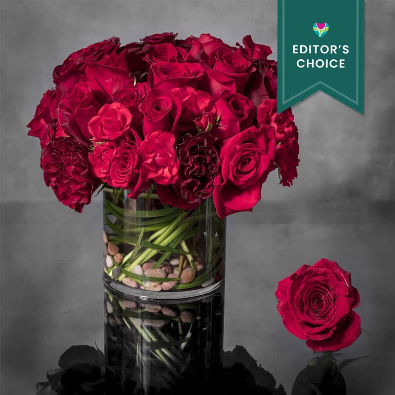 24 Red Roses - Free Delivery - Editor's Choice - Ignite your passion for fresh aromatic florals with this arrangement of 2 dozen of a variety of South American Red Roses and garden roses in a vase. Each precious petal represents one of the countless reasons that she's the one you can't get off of your mind.  As shown: 2 Dozen roses Deluxe: 3 dozen Premium 4 Dozen  Approx. 8&quot; round