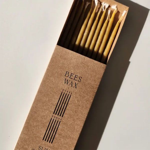 Beeswax Slim Candles - 100% beeswax  Hand dipped  Each box Includes 10 slim candles   When lit, the candles produce a soft, honey-like aroma, and beautiful warm glow.  Beeswax is the only known fuel that actually helps to clean the air of dust, odours, molds, viruses and environmental toxins by emitting negative ions when burned.  Use: as part of a centerpiece or as accents on a side table/ before bed, as the warm honey aroma is known to produce better sleep/ for ceremonies and rituals. Great for birthday cakes too!  Beeswax is naturally and sustainably produced by honeybees.