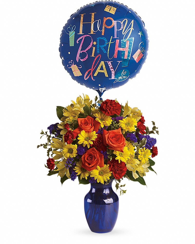 Fly Away Birthday Bouquet - Make birthday spirits soar by sending this fabulously fun birthday bouquet and balloon. Bright primary colors make it perfect for guys and gals. Years may fly by but that doesn't mean birthday celebrations need to! Brilliant orange roses, yellow alstroemeria, red carnations and miniature carnations, yellow daisy spray chrysanthemums, purple statice and a big bright balloon are all delivered in a beautiful cobalt blue vase. It's a thumbs-way-up choice in birthday gifts!Approximately 16 3/4&quot; W x 19 1/4&quot; H
