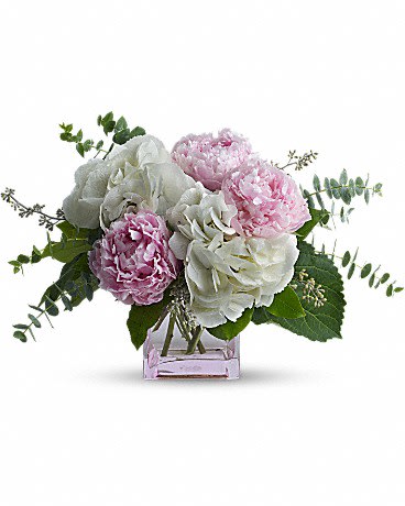 Pretty in Peony  - Good and girly! A fabulous pick for a stylish sister, friend or girlfriend, this trendy peony bouquet pairs lush, cloud-white hydrangea with the luscious beauty of pink peonies. The modern feminine arrangement is presented in a fun pink glass cube vase she's sure to use again and again.