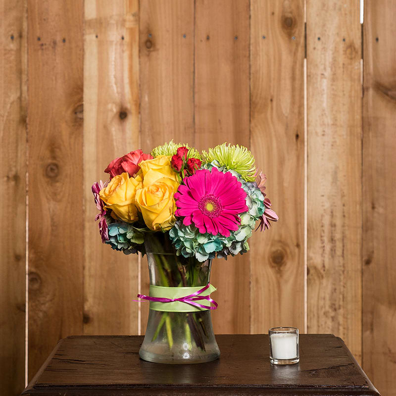Fashionista Florals Bouquet Fashionista Florals Bouquet - Fashionably beautiful, this design has been a long time favorite! A harmonious pairing of flowers such as hydrangea, roses, gerbera daisies, spider mums and accent flowers presented in a clear gathering vase accented with ribbon.