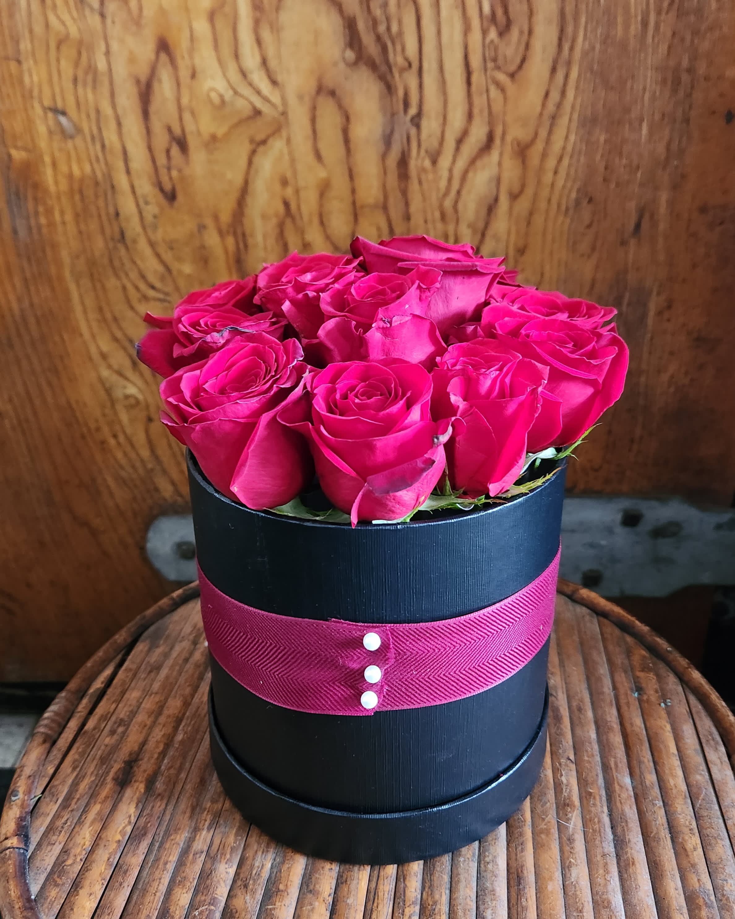 Baker's Dozen Baker's Dozen - 13 stems of red roses presented in a hatbox style container. Accented with ribbon, this minimalist look is a great alternative to the traditional dozen.