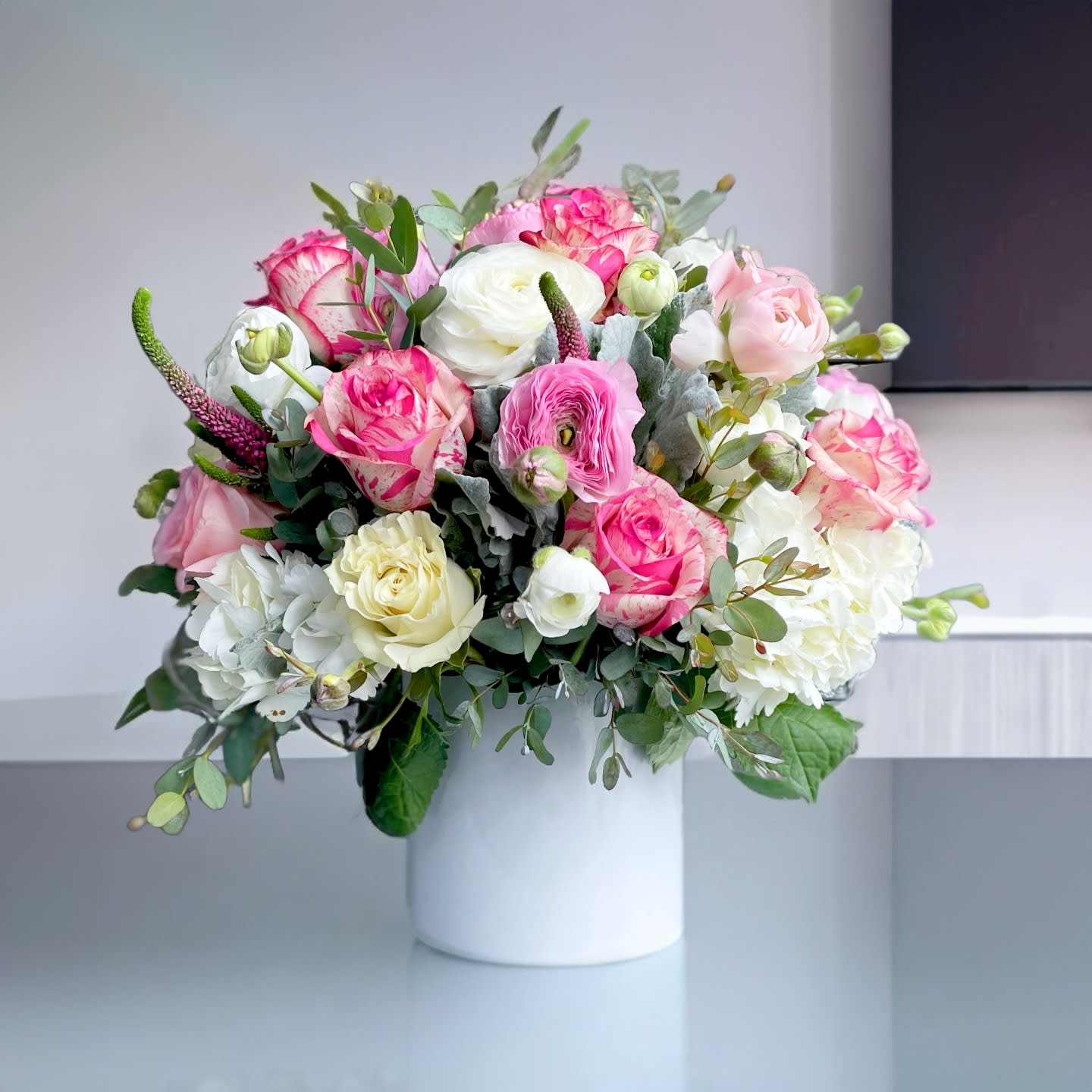 Beverly blossoms &lt;3 - This stunning floral arrangement features a luxurious mix of blush pink and ivory garden roses, white hydrangeas, and soft ranunculus blooms, beautifully accented with lush greenery and seasonal foliage. Artfully designed in a sleek, modern white ceramic cylinder vase, this romantic bouquet blends classic charm with contemporary elegance — making it a perfect choice for anniversaries, birthdays, Mother's Day, or as a sophisticated floral centerpiece for home decor or special events. The soft pastel palette and high-end floral selection make this piece ideal for clients seeking premium flower delivery in Los Angeles, especially in neighborhoods like Brentwood, Beverly Hills, West Hollywood, and Santa Monica. Handcrafted with care by Touch Of Orchids LA, this arrangement showcases the finest in luxury floral design, using only the freshest blooms available. Whether as a heartfelt gift or a décor upgrade, this bouquet brings timeless beauty and a touch of elegance to any setting.