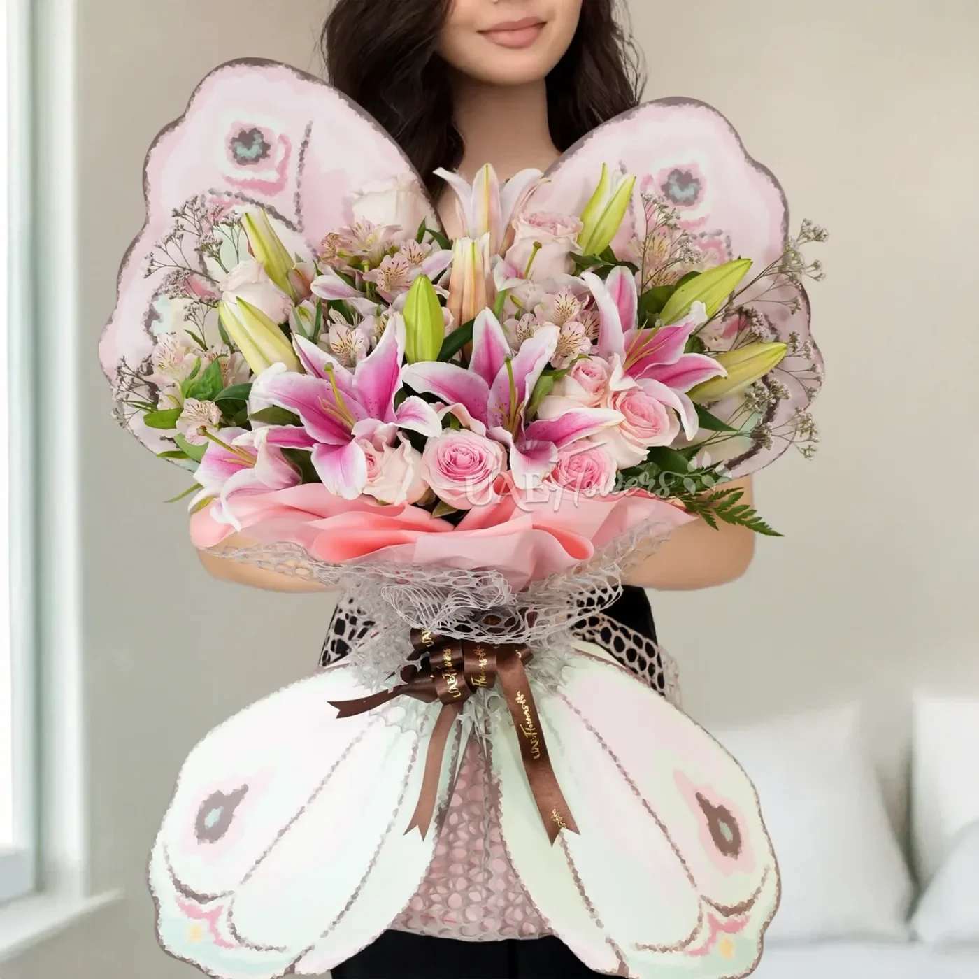  Admiration and Prosperity Bouquet  - This charming butterfly-shaped bouquet features a delightful blend of 3 pink lilies, 10 pink roses, and 3 pink alstroemerias, all beautifully accented with limonium and lush green fillers. Tied with elegant ribbons, this arrangement exudes grace and beauty, making it a perfect gift for special occasions or as a thoughtful expression of affection.