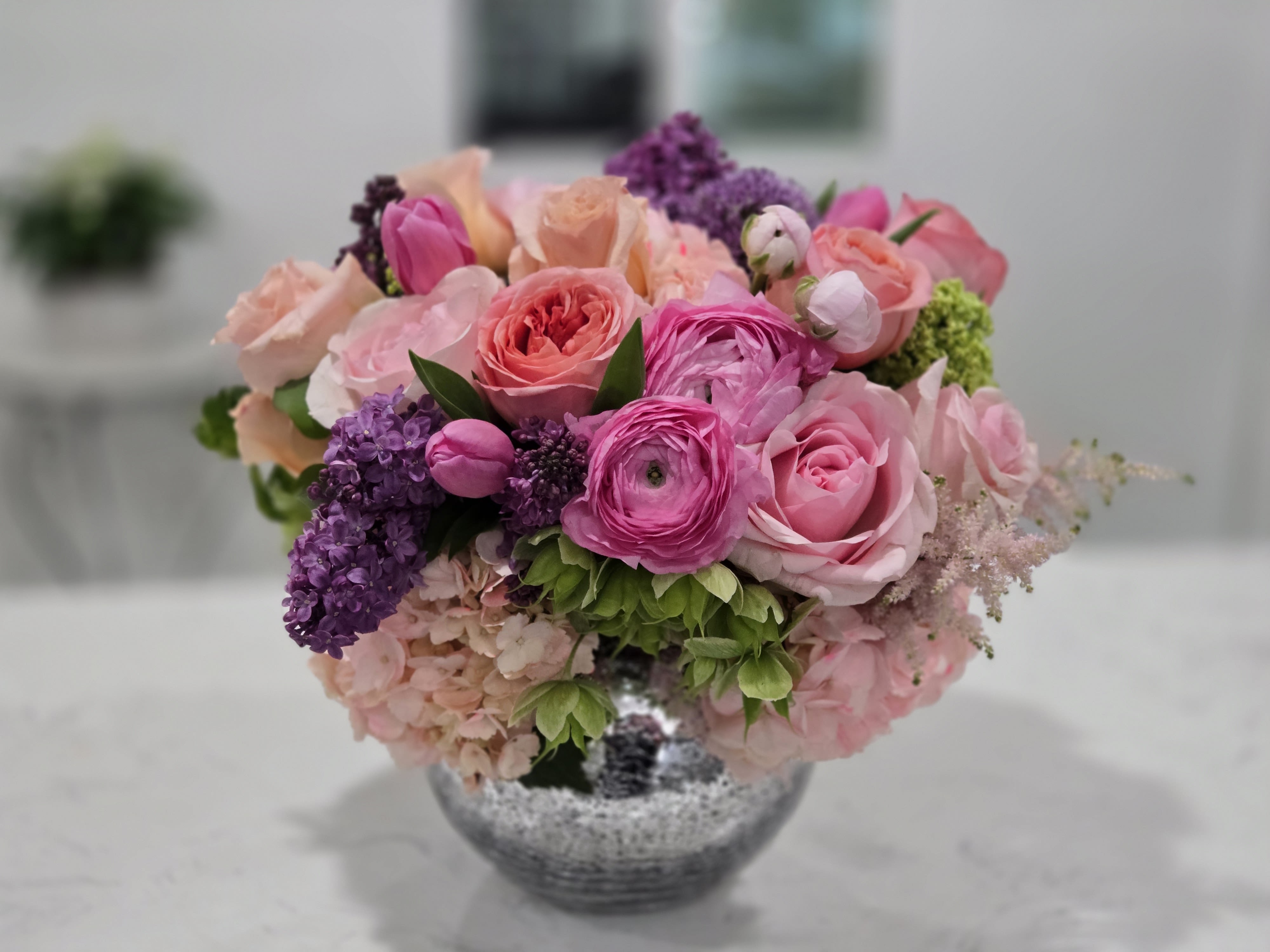Pretty in Pink - A feminine and charming arrangement of soft pink roses, hydrangeas, and lisianthus, complemented by delicate greenery for a dreamy and elegant touch.