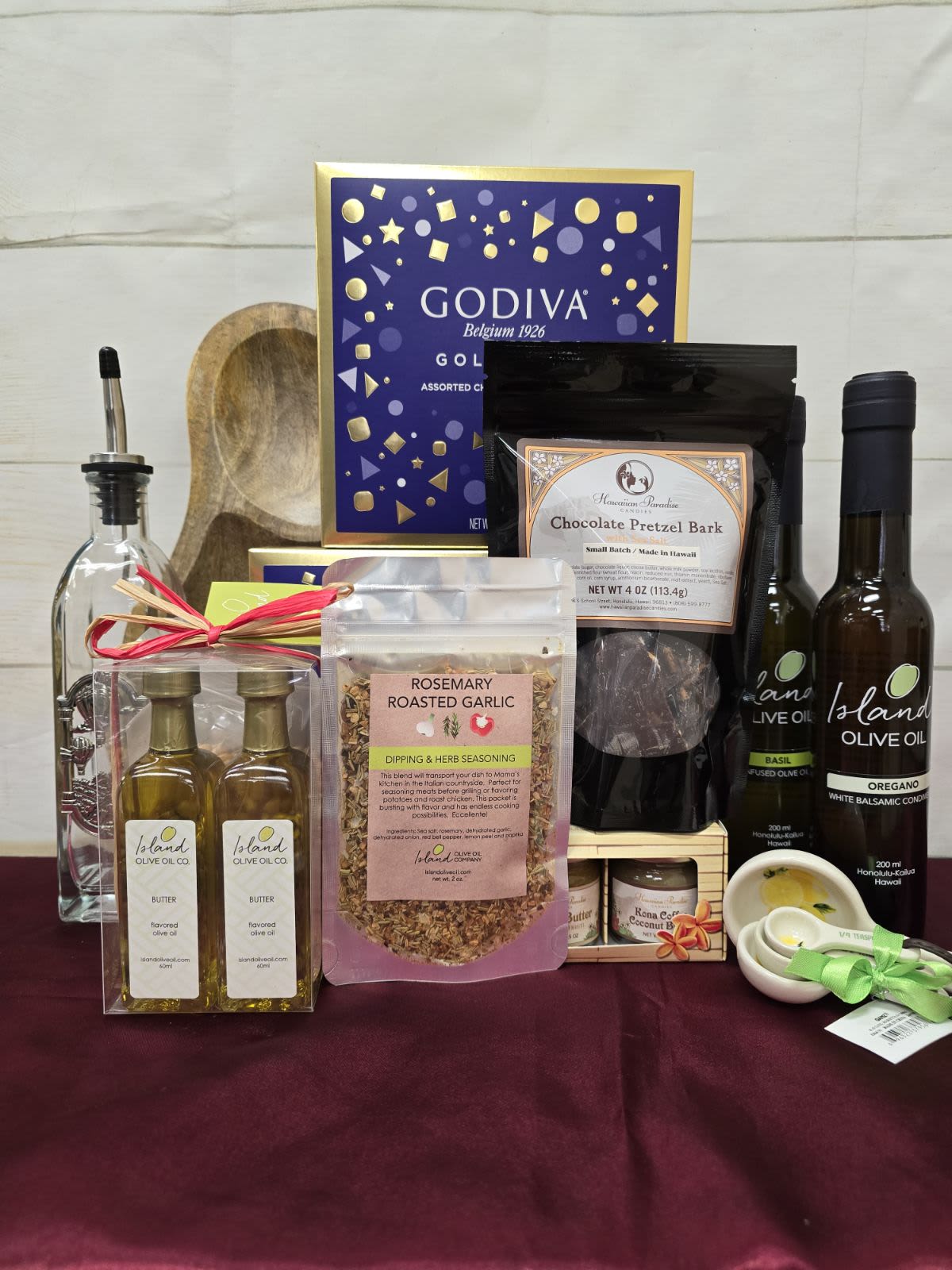 Local Partners Gourmet basket, price $200 (individual retail value $220) - AMAZING Gourmet Set  Featuring products from some of our best partners, this AMAZING set is a true delight for gourmet enthusiasts. Valued at $200, this premium basket includes:  1 IOO Flavored Olive Oil (substitute macadamia or sesame) 1 IOO Balsamic Vinegar 1 Oil Glass Bottle 1 IOO Dipping Blend 1 HPC Fruit Butter Set (3 - 1.5oz jars) 1 Serving Board with Spreader 1 Measuring Spoon Set 1 HPC Pretzel or Almond Cluster 1 IOO Popcorn Kit 1 Godiva 18pc Goldmark Gift Box This curated collection of gourmet goodies is perfect for anyone who loves high-quality, delicious treats.  