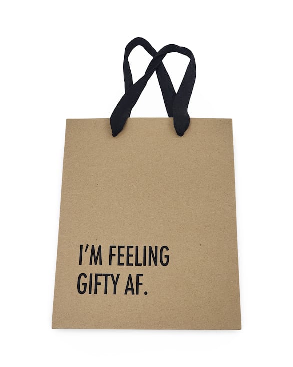 Novelty Gift Bags - Add a little humor to your gift-giving with our brown novelty gift bags featuring black handles and cheeky PG-13 sayings! Each bag comes with a different funny message—perfect for birthdays, graduations, or just because. Sayings will vary, but we’ll do our best to match the vibe of your occasion. Whether you're wrapping up a gag gift or just want the bag to get a laugh before it’s even opened, this is the one to grab!   If you order giftable items along with the bag, we’ll place them inside for an easy, ready-to-go presentation. If you do not want this, please specify in the special instructions section. Please note: flowers cannot be placed in the gift bag. 