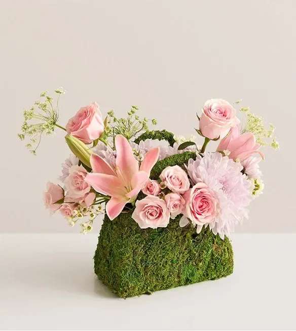 Palermo blush Palermo blush - NEW This just might be the most fashionable, and Insta-worthy, bouquet ever. An eye-catching array of pink roses and other blooms burst forth beautifully from a planter shaped like a handbag and clad in preserved moss. After the blooms are gone, the planter will retain its elegance, making this a truly timeless gift.