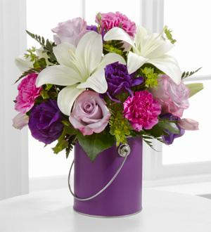 Color your day with purple Color your day with purple - Lavender roses, fuchsia carnations, purple double lisianthus, white Asiatic lilies, bupleurum and lush greens are artfully arranged within a striking purple quart size decorative paint can inspired vase to create an incredible gift they won't soon forget.