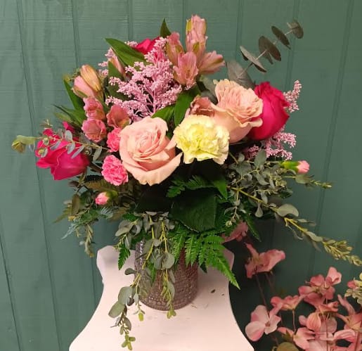 Elegant Lady - Graceful, timeless, and full of charm—just like the incredible women we celebrate. Elegant Lady is a stunning arrangement featuring luxurious hot pink roses, delicate light pink spray roses, and soft pink alstroemeria, all beautifully accented with light pink miniature carnations and vibrant green carnations. Designed with fantastic greenery, this bouquet exudes elegance and warmth, making it the perfect tribute to a mother’s strength, love, and beauty. A gift as refined and heartfelt as she is. 