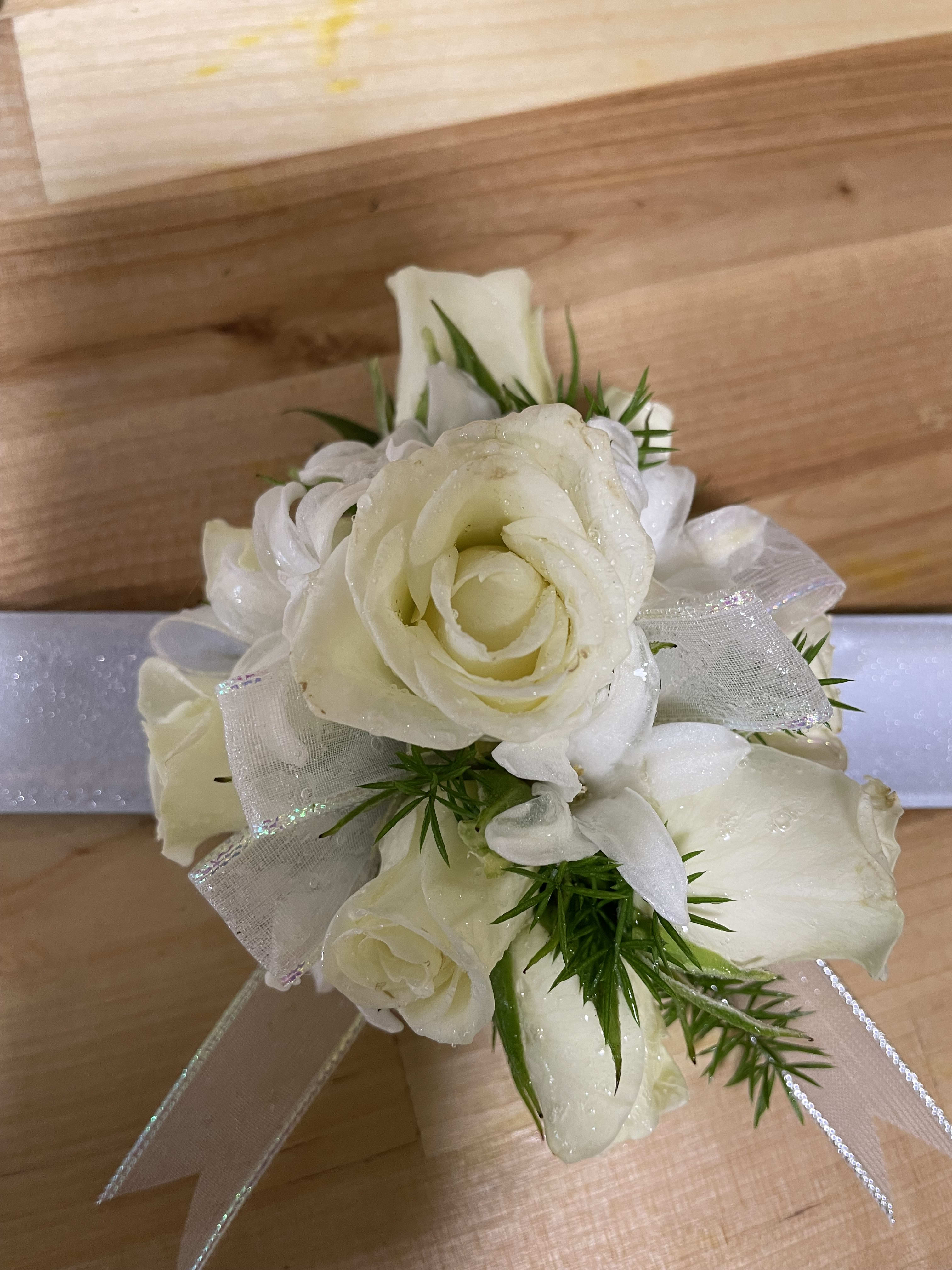 White corasge White corasge - A white corsage for prom and weddings! Corsage colors and ribbon can be changed upon request.