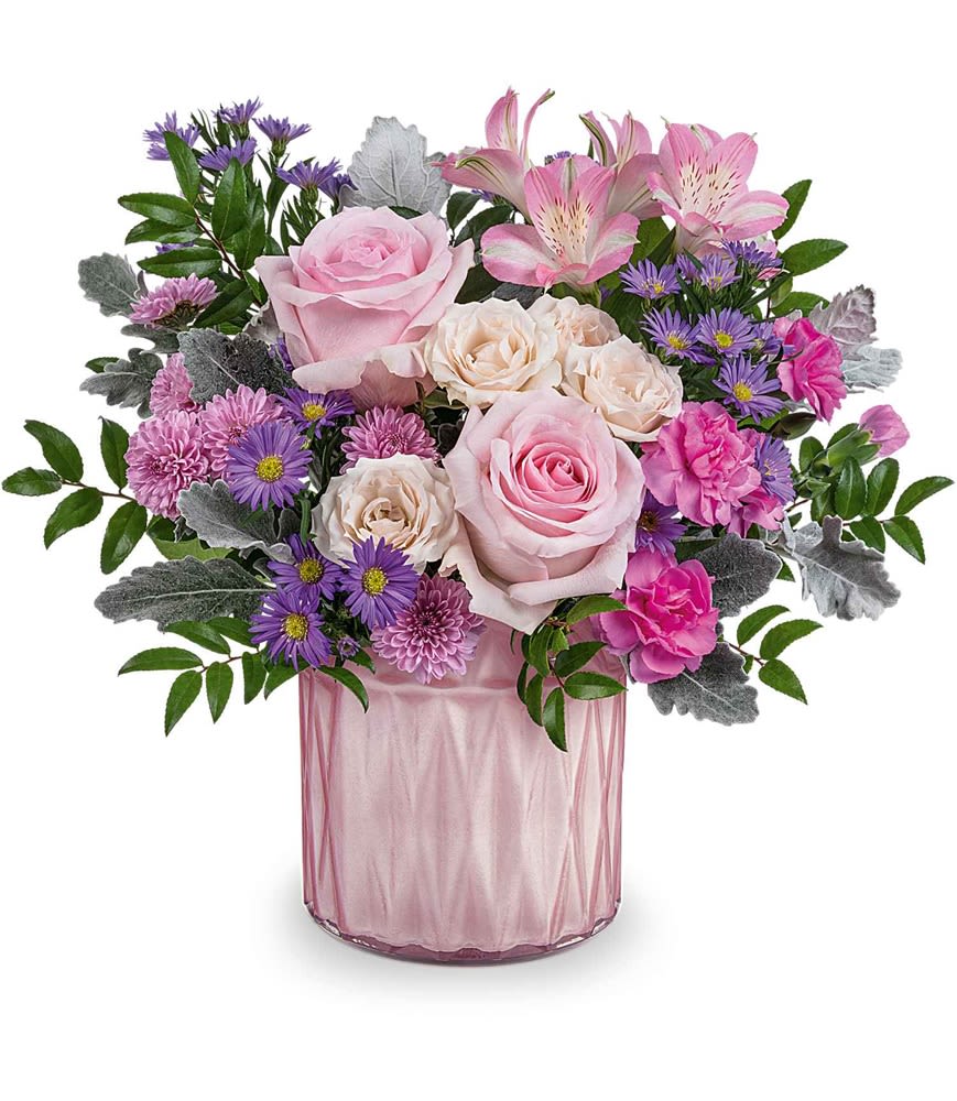 Dazzling Gem - Add a touch of elegance to any space with the Dazzling Gem Bouquet, a stunning arrangement of pink and purple blooms. Designed in a pink pearlescent vase that shimmers with timeless beauty, this radiant centerpiece is a gift to be cherished for years to come.  The Dazzling Gem Bouquet features a gorgeous mix of pink roses, crème spray roses, pink alstroemeria, hot pink miniature carnations, lavender button spray chrysanthemums, large purple Monte Cassino asters, dusty miller, and huckleberry. Artfully arranged in a pink pearlescent vase, it's a radiant and timeless gift.