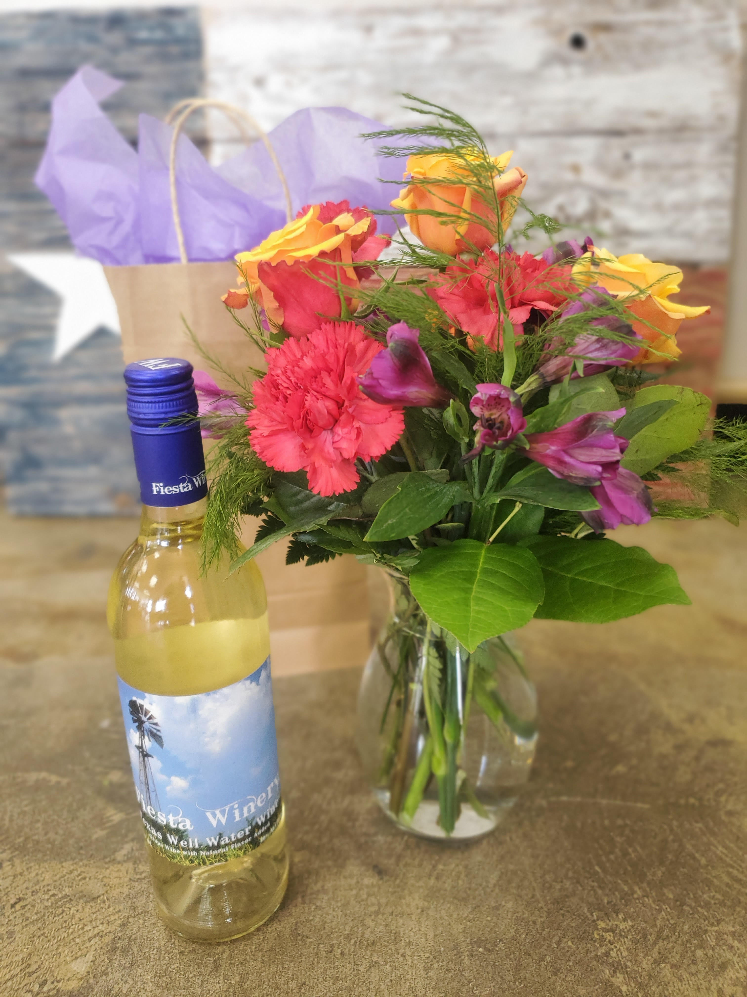 Designer's Choice Bouquet &amp; Wine - One bottle of wine with a Designer's Choice Bouquet to match. Let our designers use their natural talents and creative freedom to personalize a 100% custom bouquet for you. Please provide preferences of Wine and Color/Flower scheme at check out so we have some direction otherwise we will use our own judgement to fulfill your order if we cannot reach you.  Standard: Featured in picture, shows the size and approximate flower stem count of your design. Deluxe and Premium arrangements will increase the value of flowers and or vase accordingly.  **IMPORTANT INFO: Orders containing alcohol must be purchased by individuals over the age of 21, or of legal drinking age in your area. Delivery MUST be within our serviced area and must be accepted by an individual over 21 with valid ID. Deliveries can not be delivered to areas where consumption is prohibited (business offices, campus dorms, etc.).