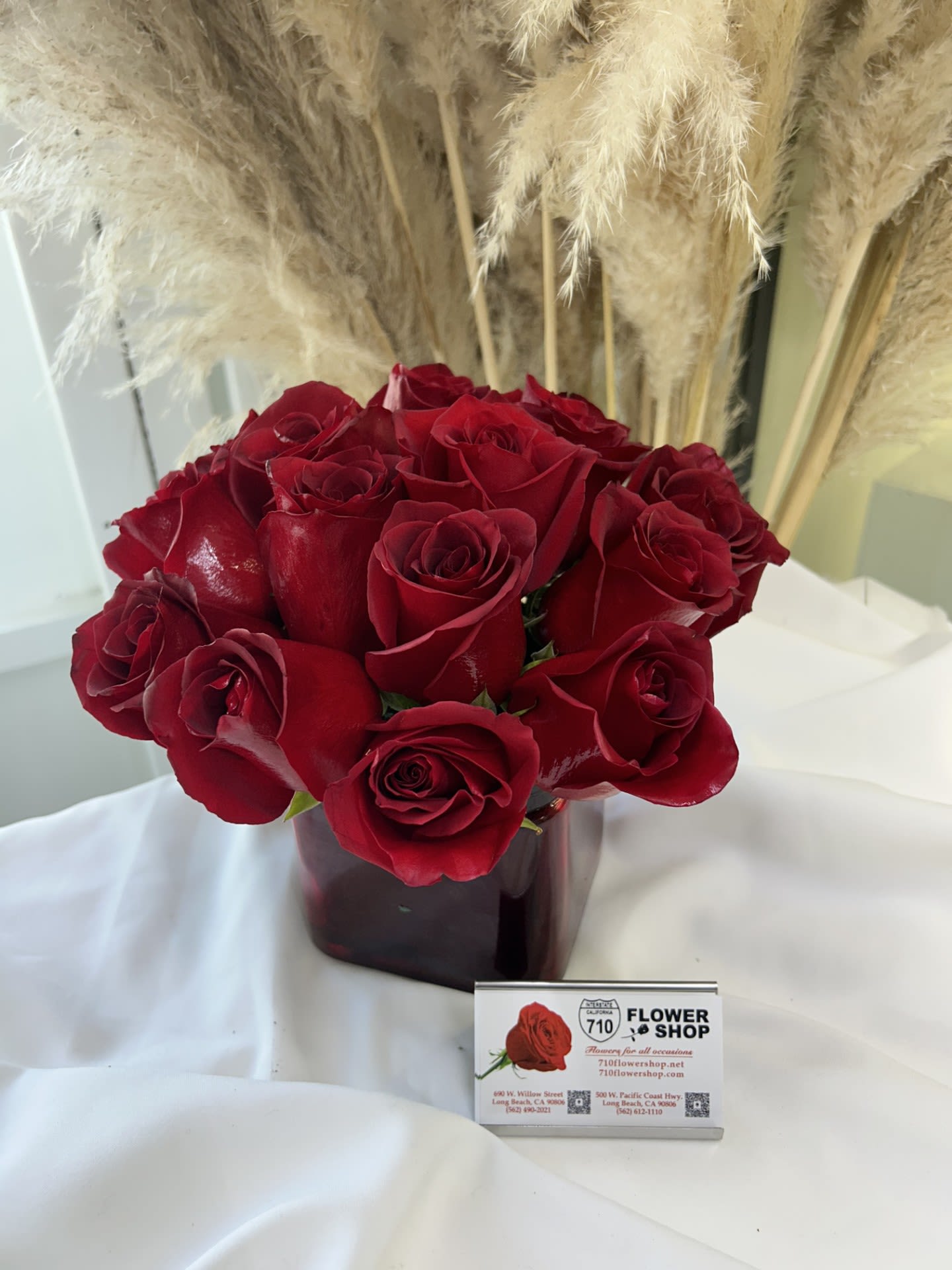 Radiant in Red - This bold yet tasteful bouquet is the perfect size for any desk. Radiant in Red makes a great gift for Valentine's Day, a Birthday, or an Anniversary.] If some flowers and/or the vase are not available there will be minor substitutions.  Arrangement Details: 12 Red Roses in a Cubed Vase APPROXIMATE DIMENSIONS 8&quot; H X 10&quot; L X 8&quot;W