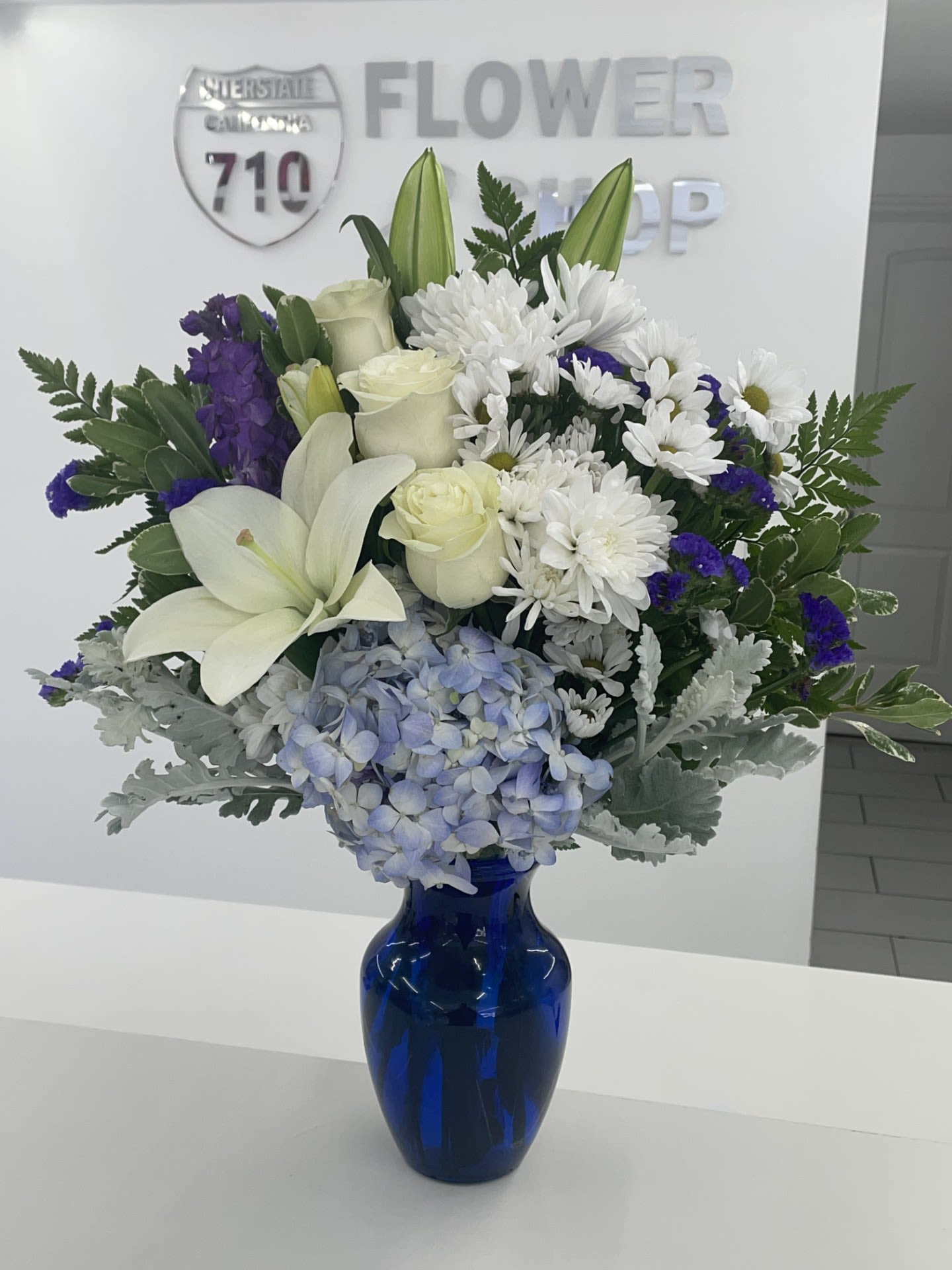 Sweet Serene by BloomNation™ Sweet Serene by BloomNation™ - This peaceful arrangement includes roses, asiatic lilies, chrysanthemums, hydrangea, carnations, and other seasonal blooms. This is a great gift to send your respects. APPROXIMATE DIMENSIONS: 14" D x 24" H