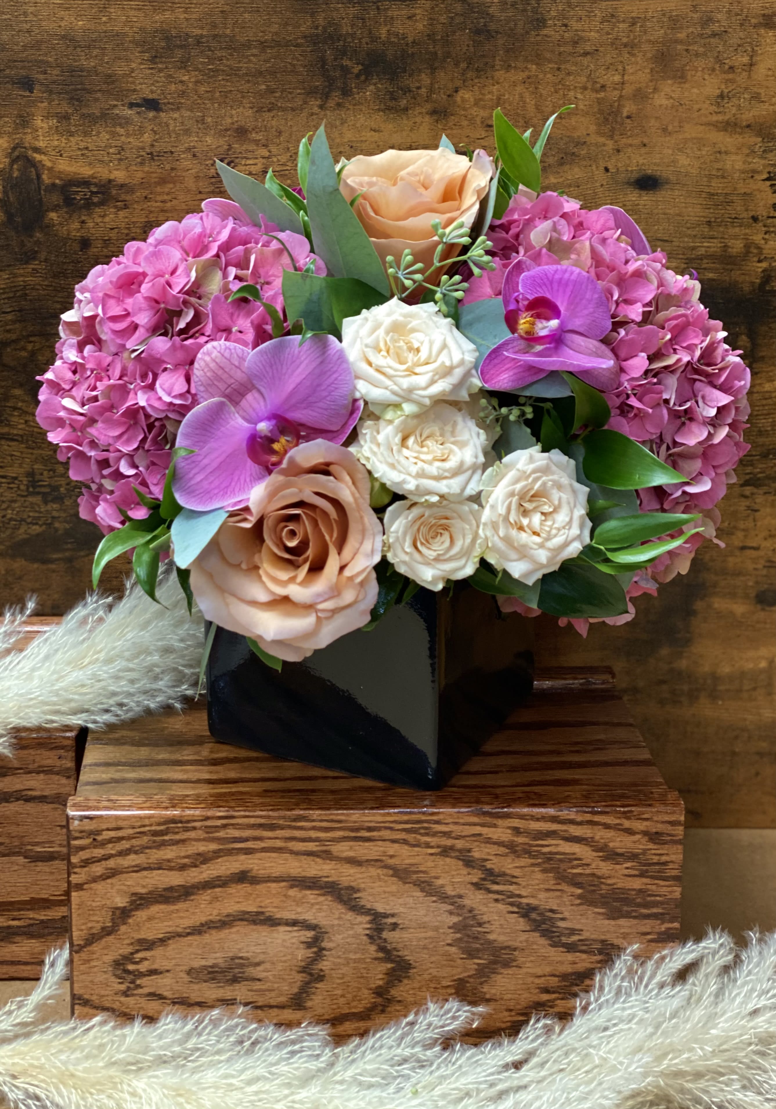 Blushing babe Blushing babe - This is a blush, pink, girly centerpiece that will certainly wow. The black vase contrasts beautifully with shades of pinks and cream