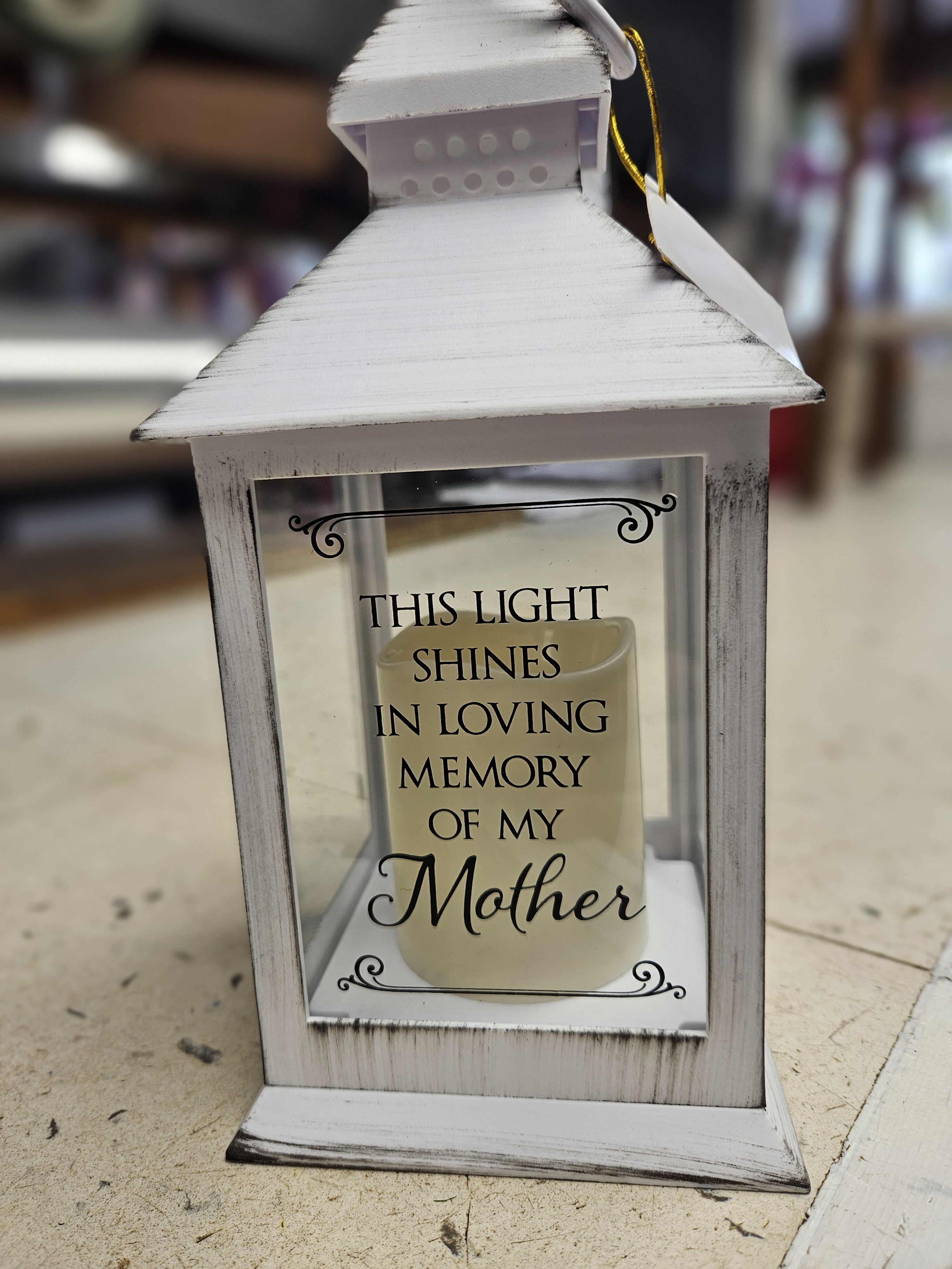 "Mom" lantern "Mom" lantern - White metal lantern with a battery candle, encircled with fresh colorful, flowers! Says "This light shines in loving memory of my Mother"