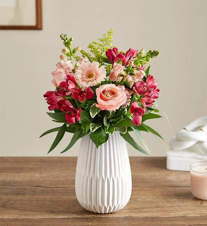 Blush Expressions Bouquet - This blush-colored gathering features hints of peach and pink, along with accents of cascading greenery. It’s arranged in our keepsake White Modern Vase, with a tapered design and matte finish that complements the beauty of every bloom.