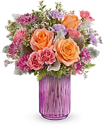 Radiant Joy Bouquet - Illuminate their spring dreams with Radiant Joy Bouquet, featuring a vibrant mix of orange, pink, and lavender, artfully arranged in a striking pink vase that shines with warmth and cheer. Light orange roses, pink spray roses, lavender carnations, and purple cushion spray chrysanthemums come together with pink limonium, dusty miller, leatherleaf fern, and oregonia. This delightful spring arrangement is delivered in Teleflora's Radiant Joy Lantern. Orientation: All-Around  SUBSTITUTION POLICY Always deliver the freshest flowers! Please note the bouquet pictured reflects our original design.  If the exact flowers or container in this arrangement are not available, our local florists will create a beautiful bouquet with the freshest available flowers. 