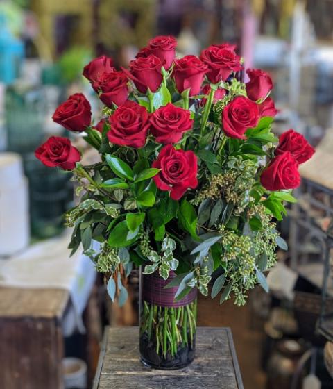 Two Dozen Red Roses Arranged Two Dozen Red Roses Arranged - Two dozen red roses with mixed greenery are arranged in a vase.