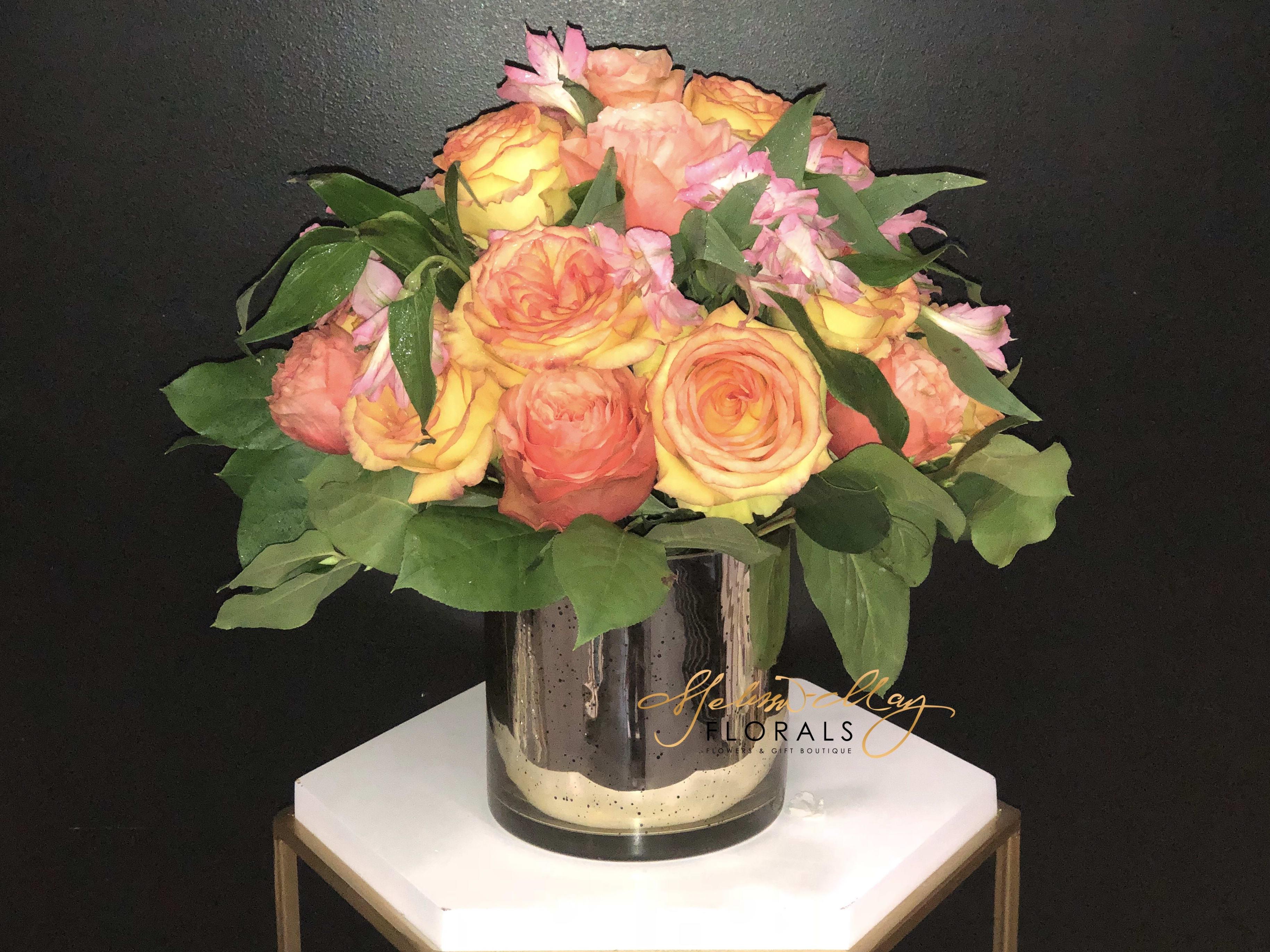 Autumn Day - This beautiful arrangement is filled with the peachy of the peachy roses you will ever find. This gold mercury cylinder vase is no ordinary vase. Its filled with a load of beautiful roses you ever land your eyes on. Come in and grab this beauty to go!