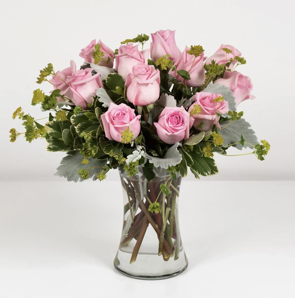 Pink Beauties - 1 Dozen- Standard Bouquet 2 Dozen- Deluxe Bouquet 3 Dozen- Premium Bouquet  Send your sweetheart a sweet arrangement of pink roses, signifying grace and poetic love. The greenery can be different depents seasonal availability. Please Note: The bouquet pictured reflects our original design for this product. While we always try to follow the color palette, we may replace stems to deliver the freshest bouquet possible, and we may sometimes need to use a different vase.