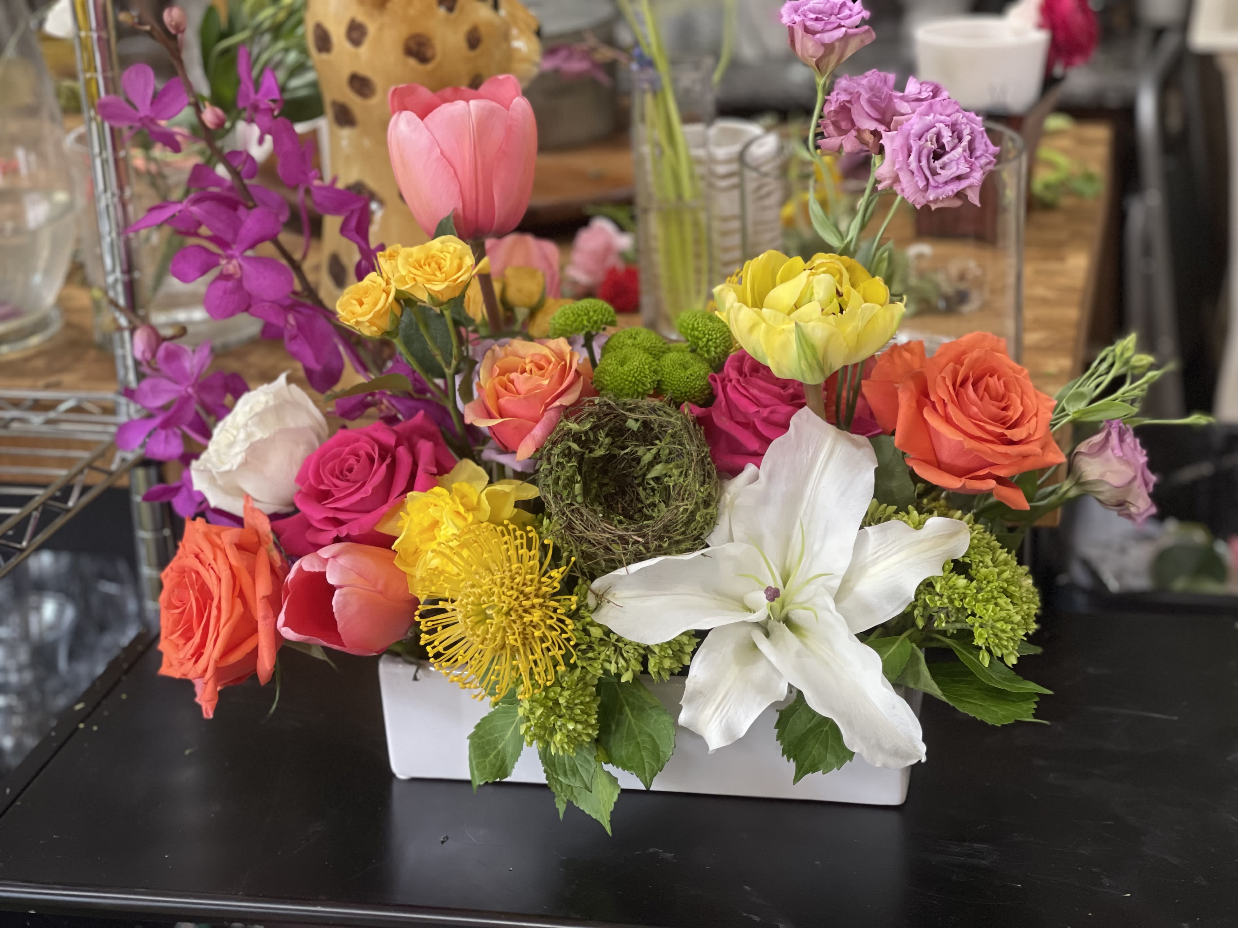 Hummingbird- (large)  - A variety of Spring seasonal blooms in a low ceramic rectangular container. 
