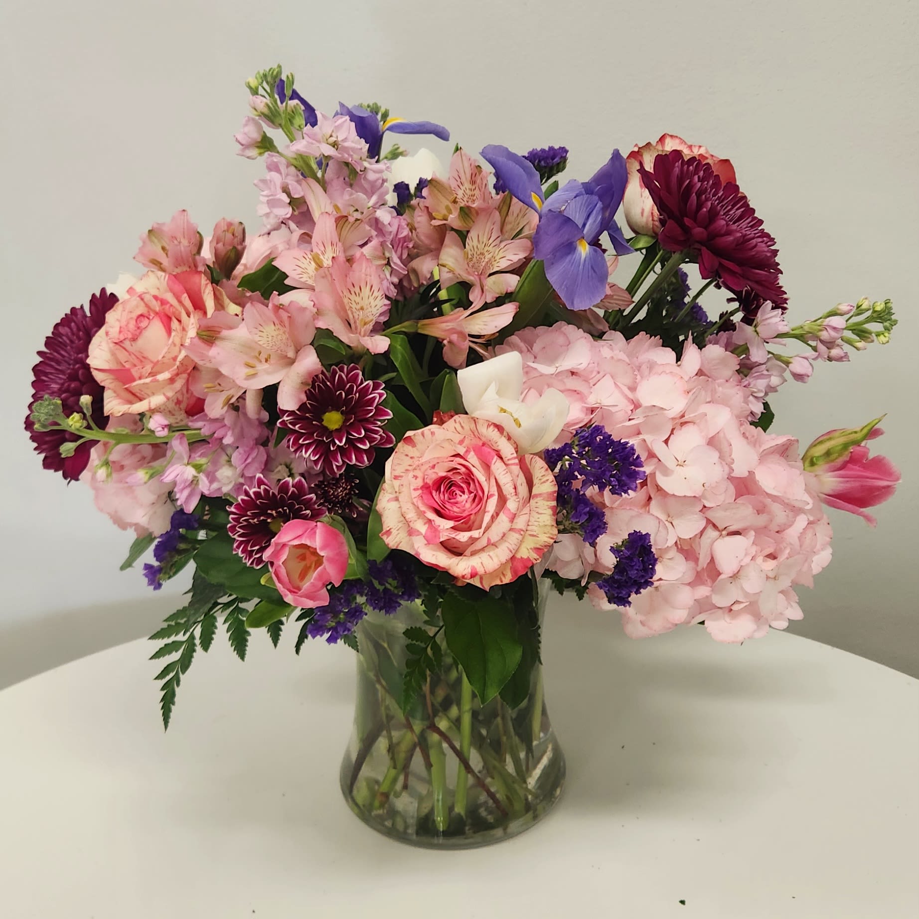 KMD2507 Lotsa Flowers Mom KMD2507 Lotsa Flowers Mom - KMD207 – Lotsa Flowers Mom This showstopping arrangement is overflowing with beauty, elegance, and charm for the mom who deserves nothing less than extraordinary. A lush and vibrant combination of premium blooms in stunning shades of pink, purple, and blue—featuring a voluminous Pink Hydrangea, luxurious Magic Times Roses, striking Blue Iris, and many more seasonal treasures. Designed to impress, this grand bouquet is the ultimate expression of love, admiration, and gratitude. If your mom is one-of-a-kind, give her an arrangement that’s just as exceptional.