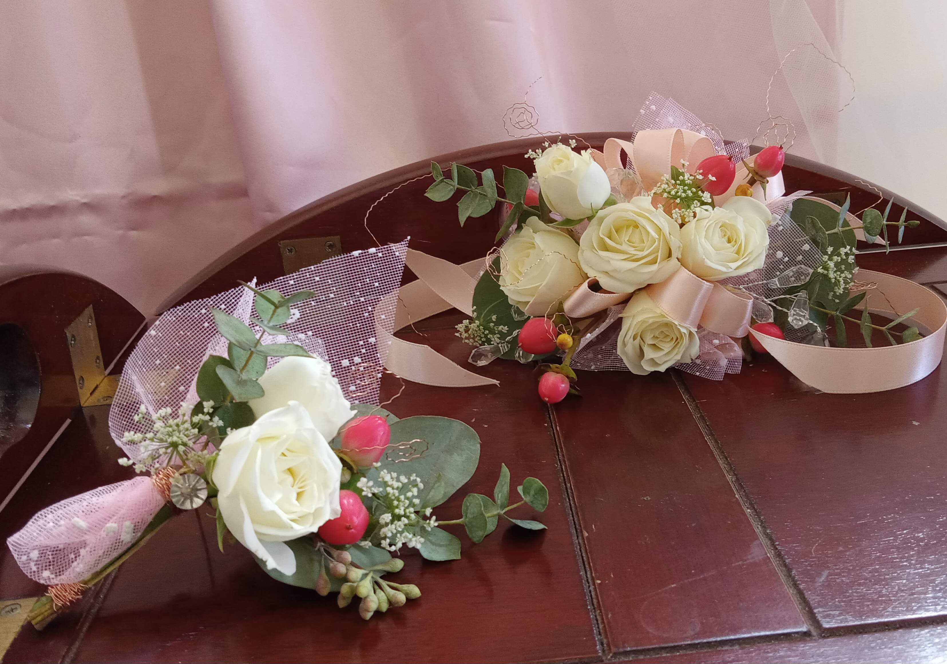 Homecoming/Prom Wrist Corsage &amp; Bout Set - Accessorize your formal attire with one of our detail-oriented wrist corsage and bout sets for Homecoming/Prom.  They are created using spray roses, seasonal greens and fillers atop a rhinestone band with the ribbon color of your choice.  We always add a few EXTRAS (rhinestones, tulle', berries, etc...) to enhance the look of the corsage/bout set.  PLEASE add your ribbon color, flower colors and any additional special floral requests in the 'NOTES' section of your order form.  As always, we are just a phone call away if you'd prefer to speak with us directly.  All 'Sets&quot; will be delivered in the morning between 9am - 12pm on the delivery date requested at the time of order.