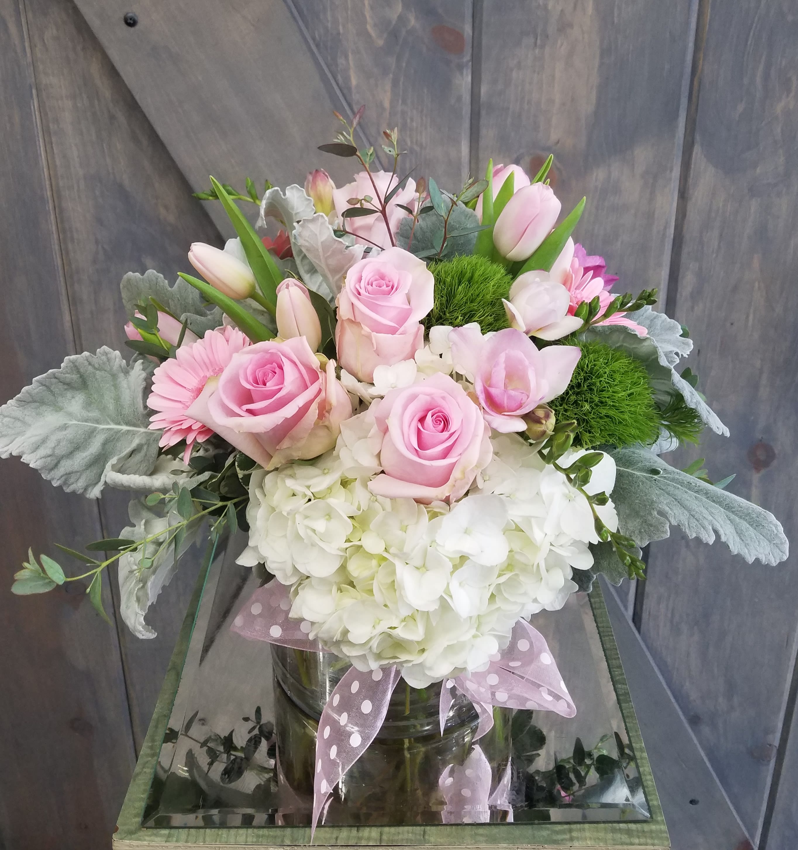 Dreams of Pink Dreams of Pink - Included in this design are Roses, Hydrangea, Tulips, Gerbera Daisys, Dianthus, and Dusty Miller arranged in a 6" Cylinder