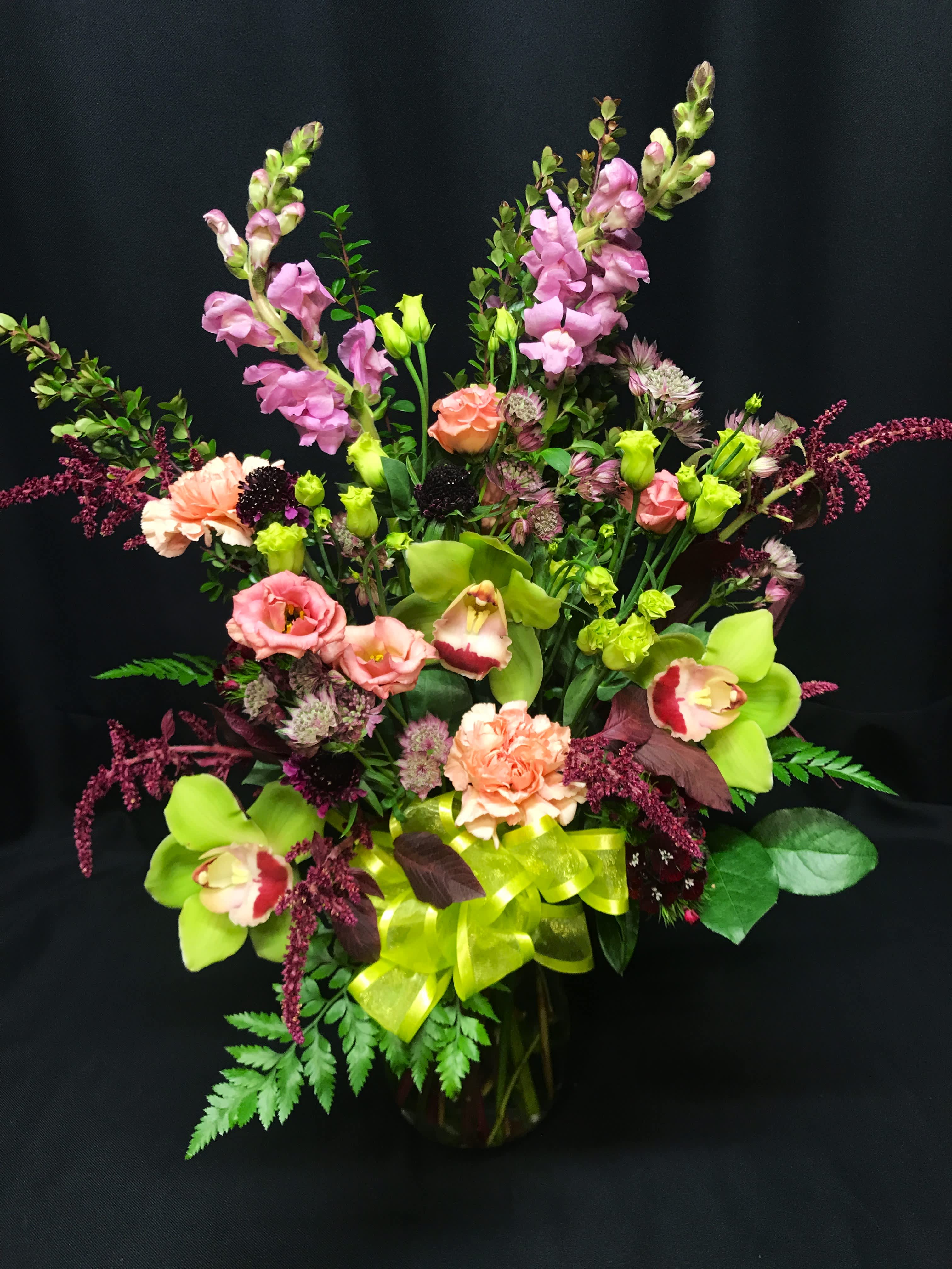 Interesting orchid mix valentine - Precious medium arrangement of lisianthes cymbidium orchids and accent flowers. Colors may vary.  Sweet choice for daughter's valentine bouquet.  