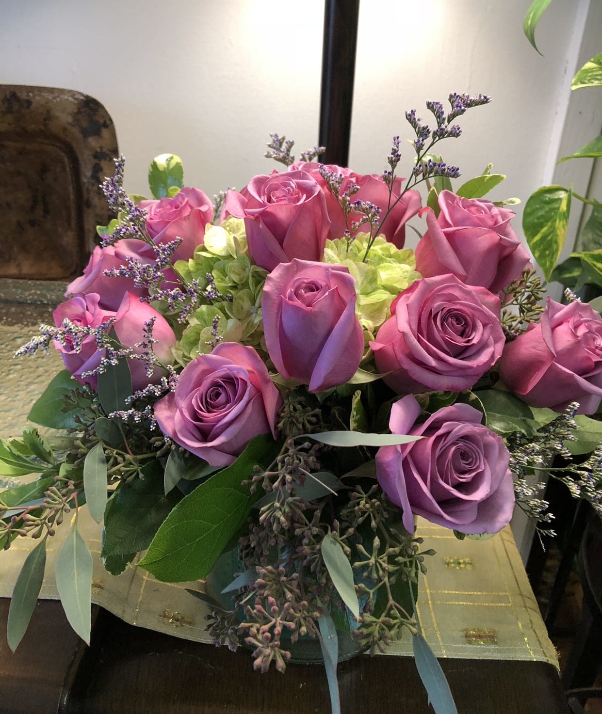 Lavender and Green bouquet Lavender and Green bouquet - One dozen lavender roses in a clear short glass vase accented with green hydrangeas The upgrade option for this bouquet is two dozen roses