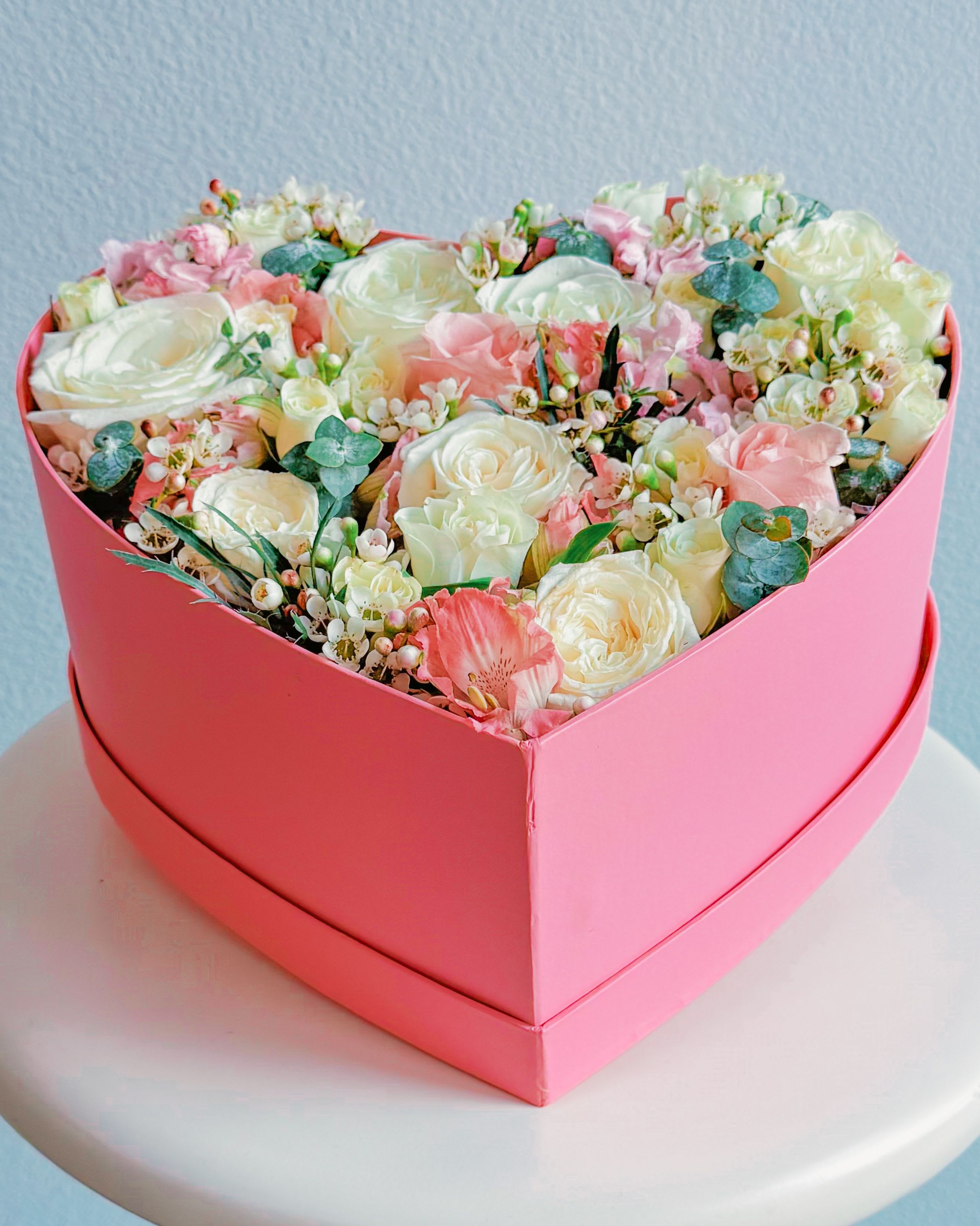 PinkHeart - This pink pastel heart box is next level cute. It’s packed with soft pink, creamy white, and blush blooms that scream romance without trying too hard. The delicate details, like eucalyptus sprigs and dainty wax flowers, make it look super classy but still chill. Perfect for Valentine’s, anniversaries, or just flexing that you know how to pick the perfect gift. Definitely made for Insta vibes—she’s gonna love it. 
