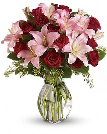 Lavish Love Bouquet with Long Stemmed Red Roses - Lovely reds and pinks come together in this lavishly romantic anniversary gift. Sweetly sentimental, this combination of colors and flowers is a delightfully fresh way to say &quot;I love you.&quot; Radiant red roses and spray roses along with pretty in pink asiatic lilies are beautifully arranged in a stylish glass vase. It's a beautiful way to celebrate a romance that deepens with each passing year.