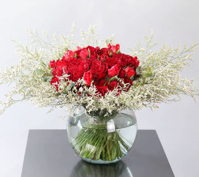 Timeless classic - This French bouquet is the timeless, traditional, classic style for the one who love this tight bouquet look. It creates by heart rose, assort tulip etc. I keep all material in different shape of red to achieve the depth and texture. This arrangement is in 8&quot; Ball vase Disclaimer: Photo just represent the overall style, look and feel, which may not be able to identically replicate in some instance. We will only substitute item of equal value or higher value. 