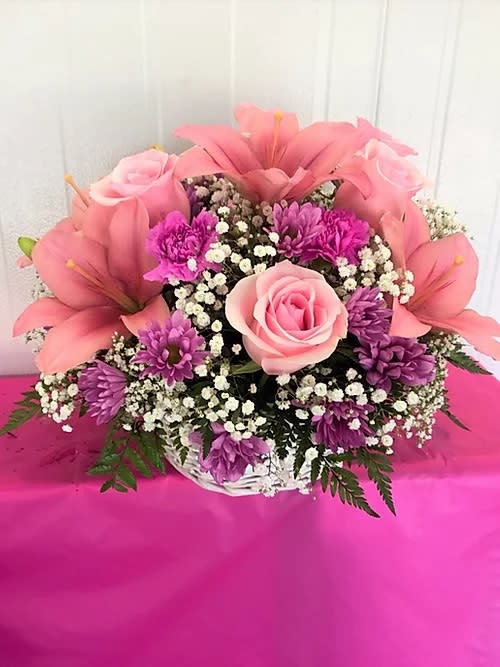 Lavender &amp; Pink Basket - The &quot;Lavender &amp; Pink Basket&quot; is one our favorites certer-piece for any occasion. It comes with 5 stem pink lillies, 6 pink roses, 4 dark pink carnations and lavender cushions, baby breathe and greenery. 12&quot; H x 10 W approx.  
