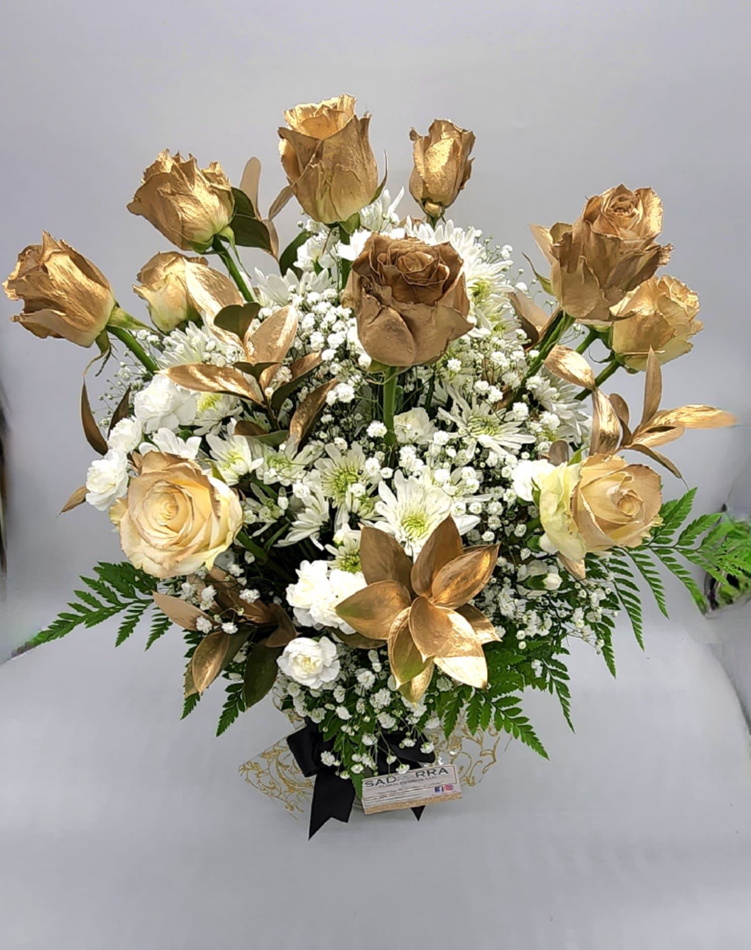 "24K GOLDEN Heart" Dozen Rose Arrangement "24K GOLDEN Heart" Dozen Rose Arrangement - A beautiful array of a Dozen Designer Choice Golden Sprayed Roses, for that someone special!